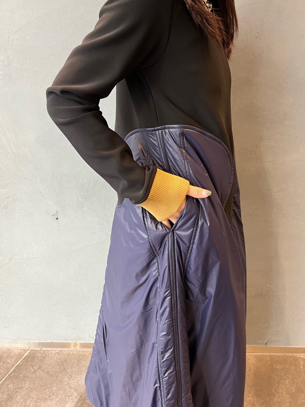 グレー系のブーツ、ブルー系のワンピース、シルバー系のネックレスを着用したレディースの秋コーディネートの6枚目の写真