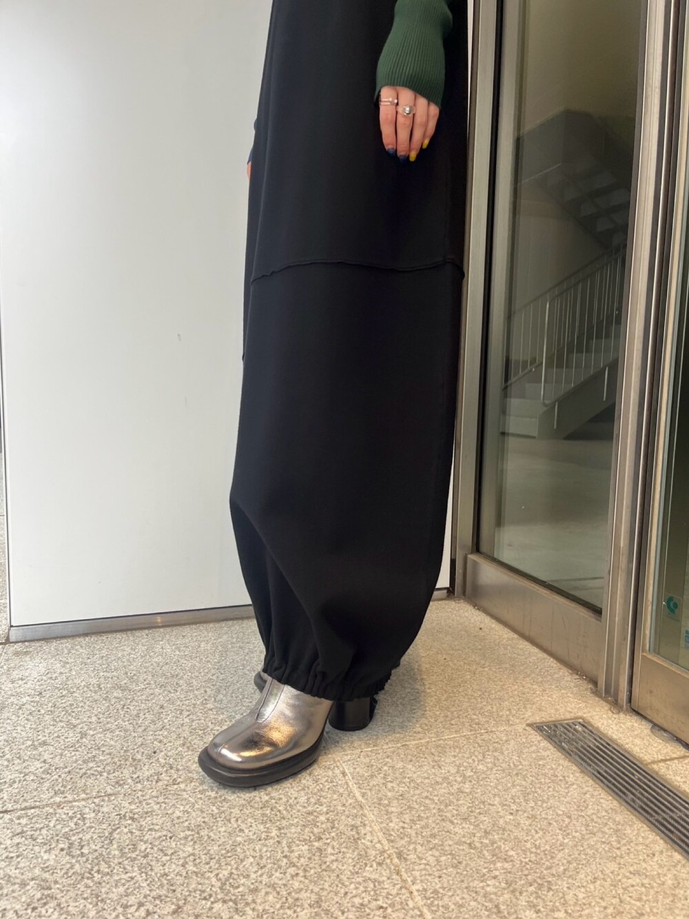 ブラック系のワンピース、シルバー系のブーツを着用したレディースの冬コーディネートの7枚目の写真