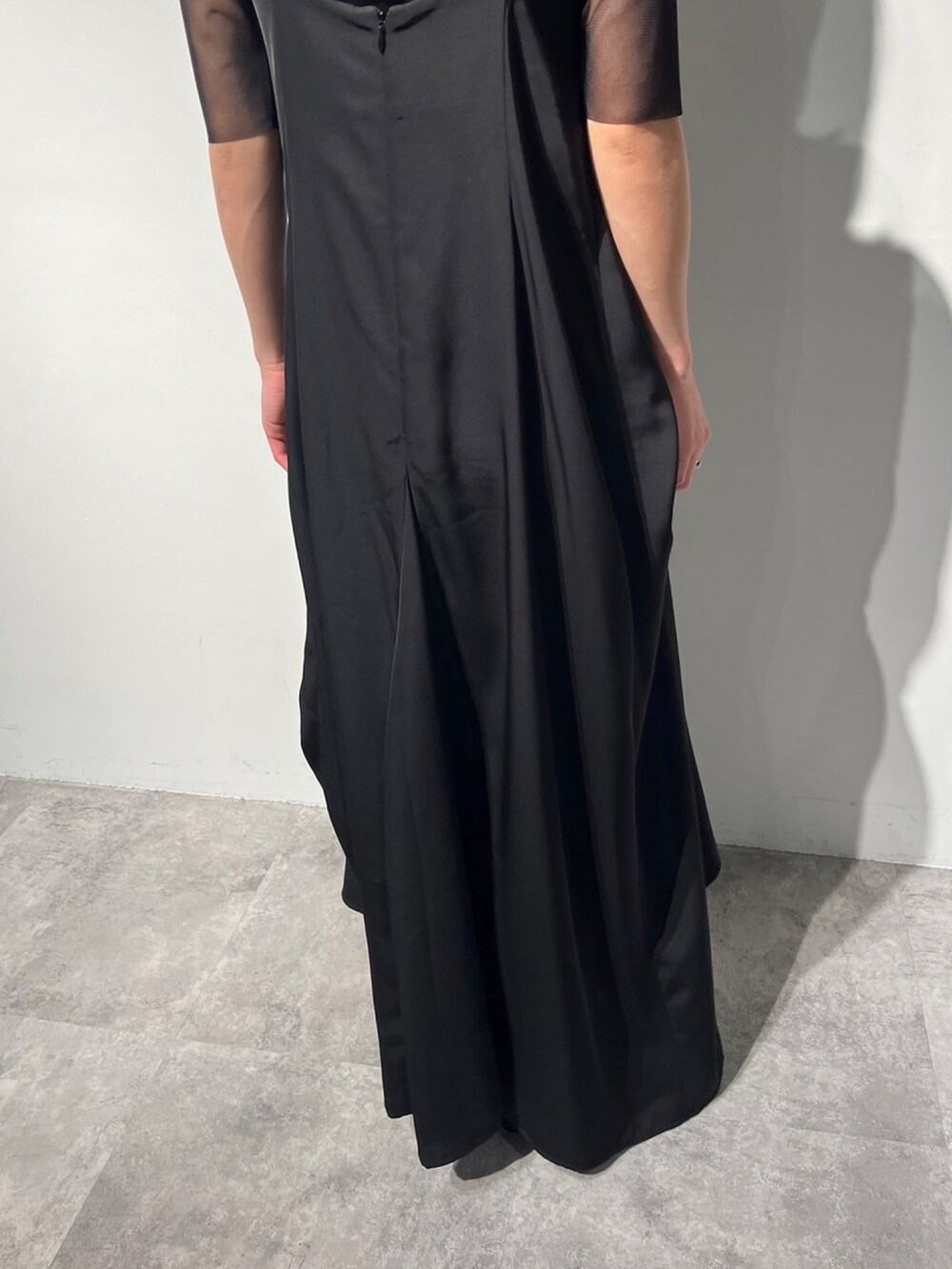 ブラック系のワンピース、ブラック系のTシャツ/カットソー、シルバー系のパンプスを着用したレディースの夏コーディネートの6枚目の写真