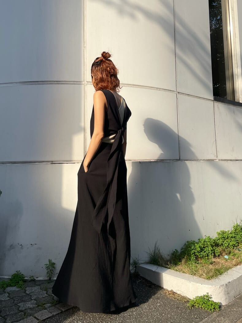 ブラック系のワンピース、ベージュ系のタンクトップを着用したレディースの夏コーディネートの4枚目の写真