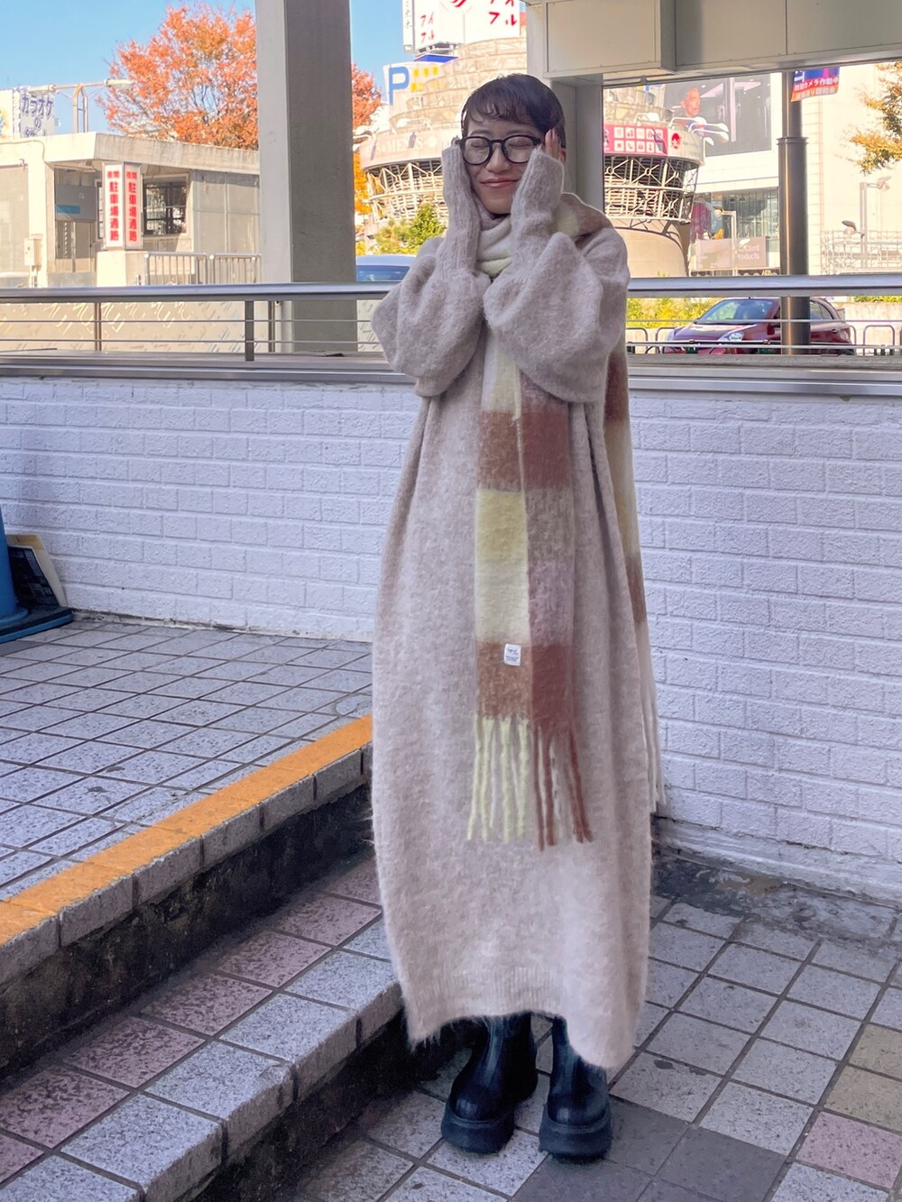 ホワイト系のワンピース、ブラウン系のマフラーを着用したレディースの秋コーディネートの5枚目の写真