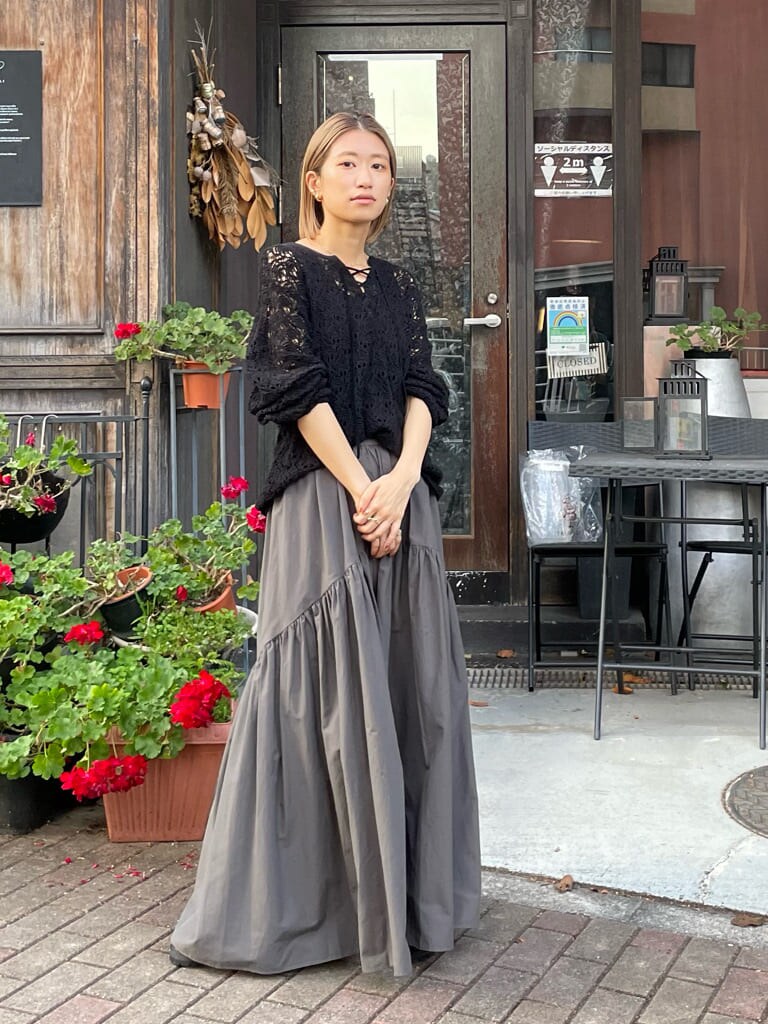 グレー系のスカート、ブラック系のニット/セーターを着用したレディースの冬コーディネートの3枚目の写真