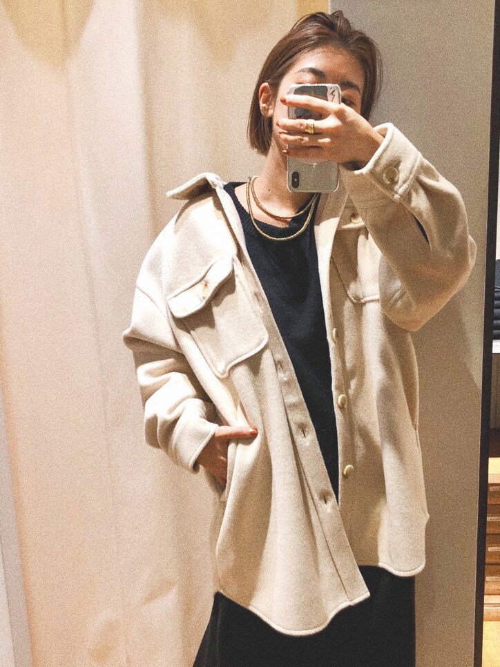 ホワイト系のシャツ/ブラウス、ブラック系のワンピース、ブルー系のデニムパンツを着用したレディースの冬コーディネートの2枚目の写真