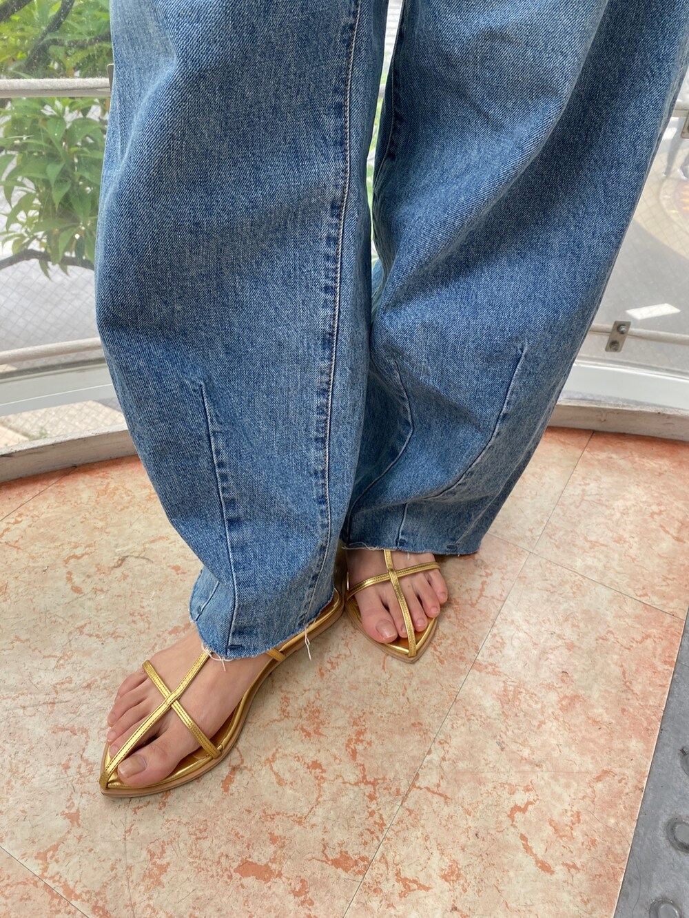 ベージュ系のシャツ/ブラウス、ブルー系のデニムパンツ、ゴールド系のサンダルを着用したレディースの春コーディネートの7枚目の写真