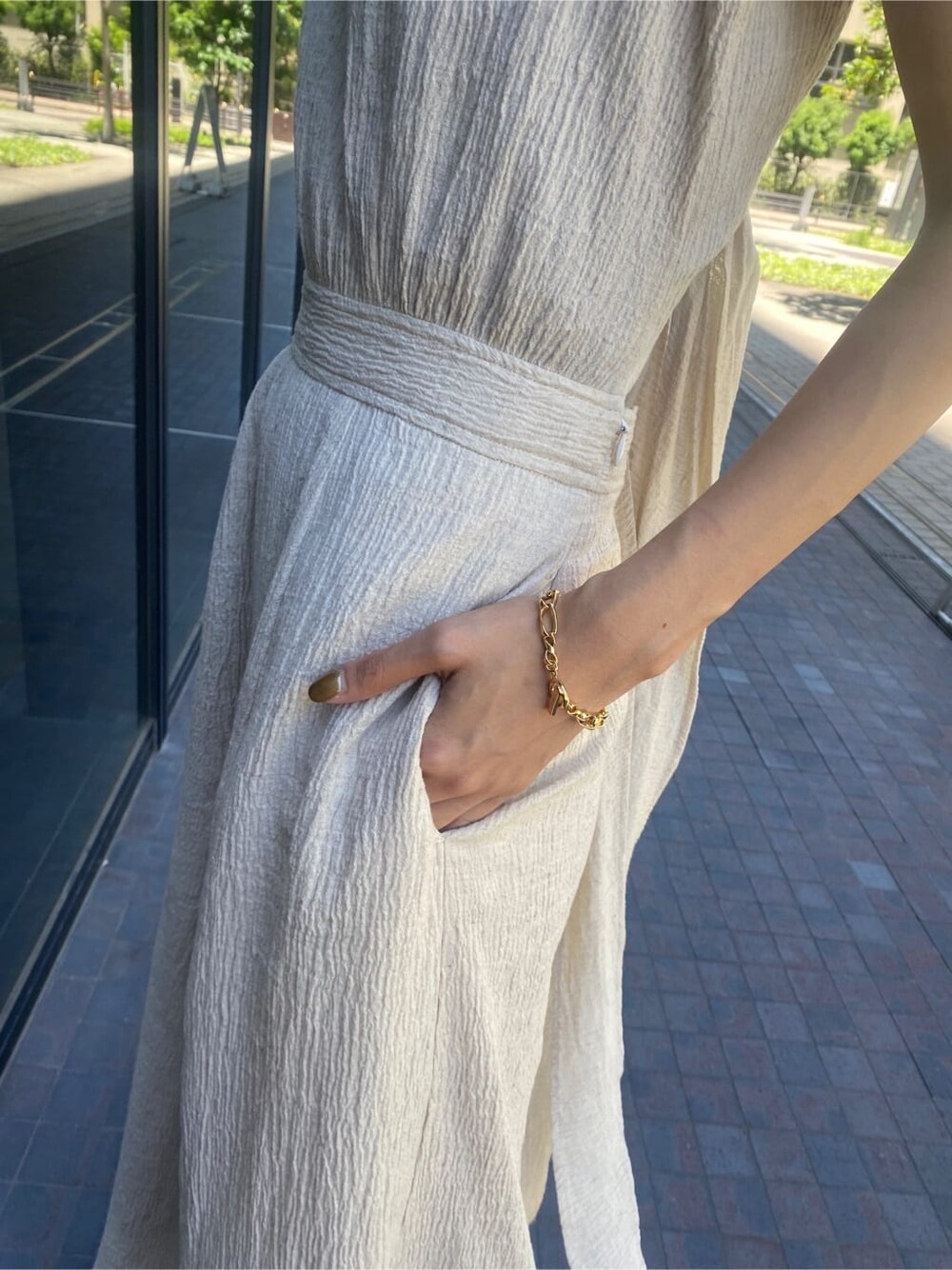 ブラック系のサンダル、ホワイト系のワンピース、ベージュ系のハットを着用したレディースの夏コーディネートの6枚目の写真