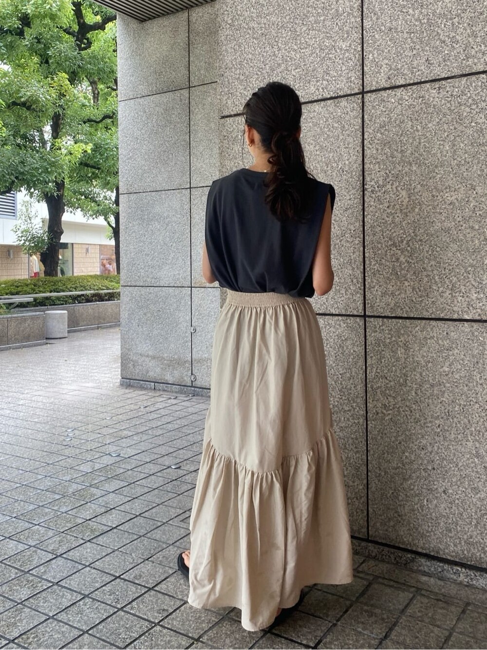 ホワイト系のスカート、グレー系のタンクトップを着用したレディースの夏コーディネートの3枚目の写真