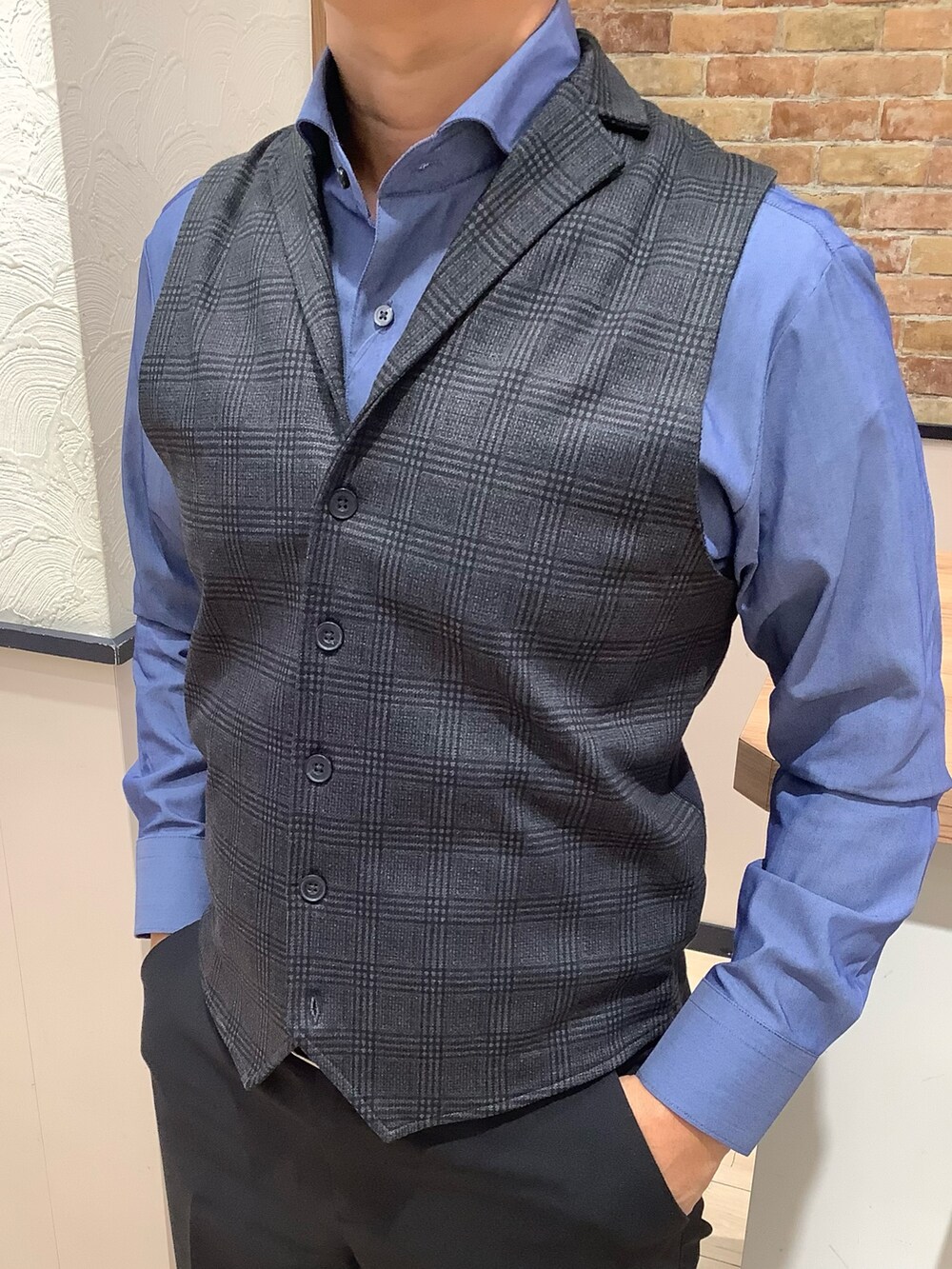 シルバー系のネクタイ、ブルー系のベスト、ブルー系のビジネスシャツを着用したメンズの秋コーディネートの3枚目の写真