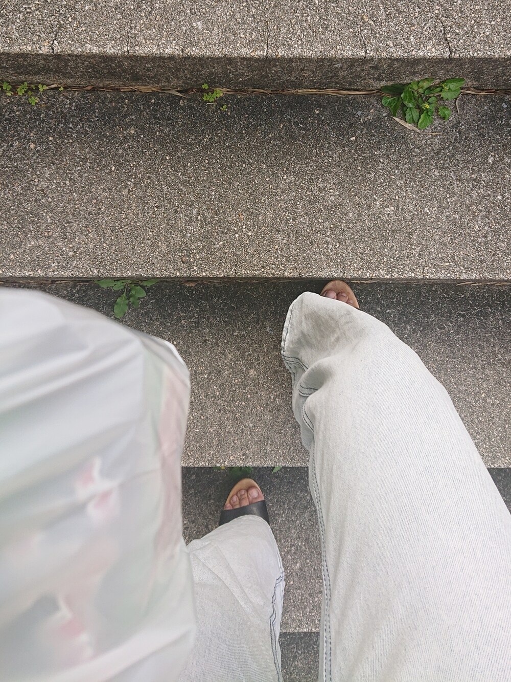 ブルー系のデニムパンツ、オレンジ系のキャミソール、ブラック系のブルゾンを着用したレディースの秋コーディネートの4枚目の写真