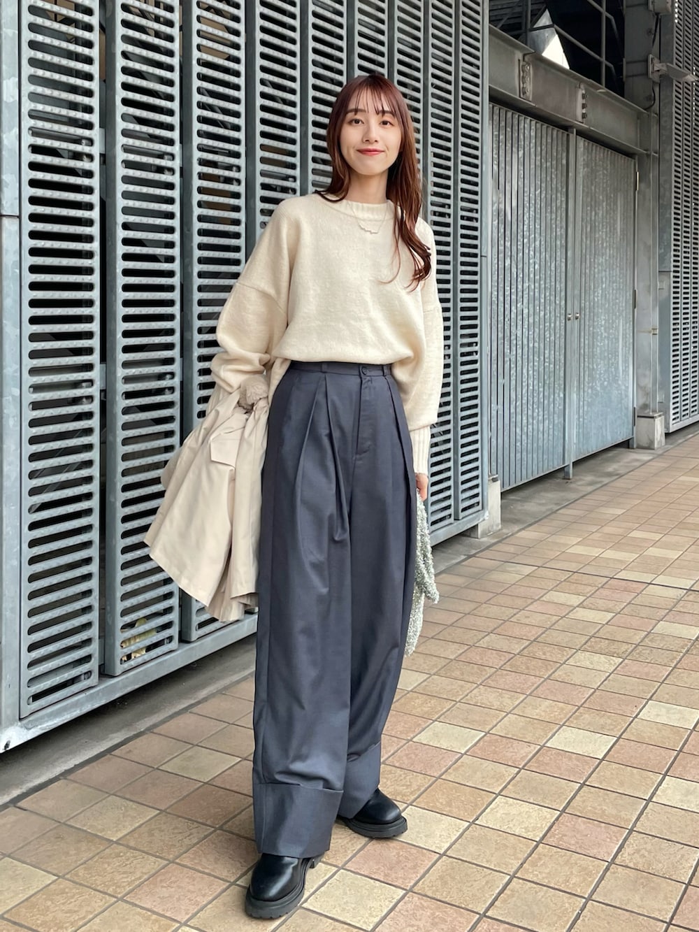 グレー系のその他パンツ、ホワイト系のニット/セーター、シルバー系のハンドバッグを着用したレディースの冬コーディネートの2枚目の写真