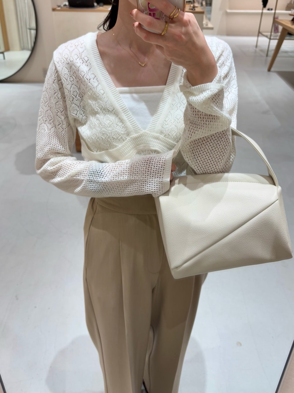 ベージュ系のその他パンツ、ホワイト系のハンドバッグ、ホワイト系のニット/セーターを着用したレディースの春コーディネートの4枚目の写真