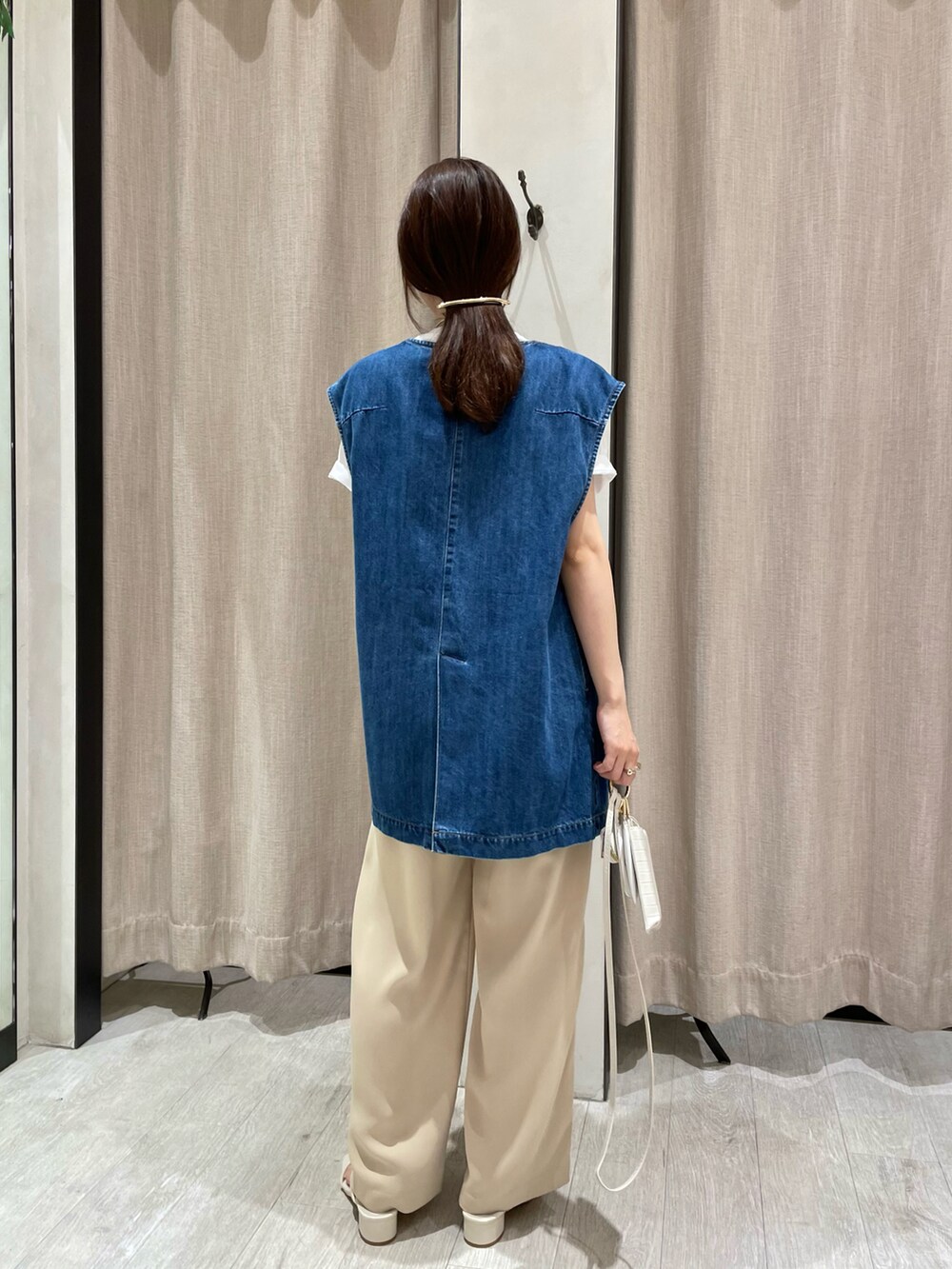 ホワイト系のTシャツ/カットソー、ブルー系のベスト、ベージュ系のその他パンツを着用したレディースの夏コーディネートの5枚目の写真