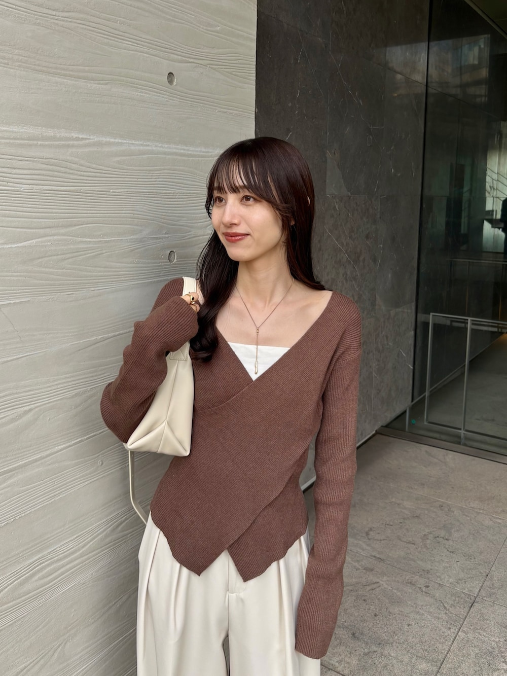 ホワイト系のその他パンツ、ホワイト系のショルダーバッグ、ブラウン系のニット/セーターを着用したレディースの秋コーディネートの4枚目の写真