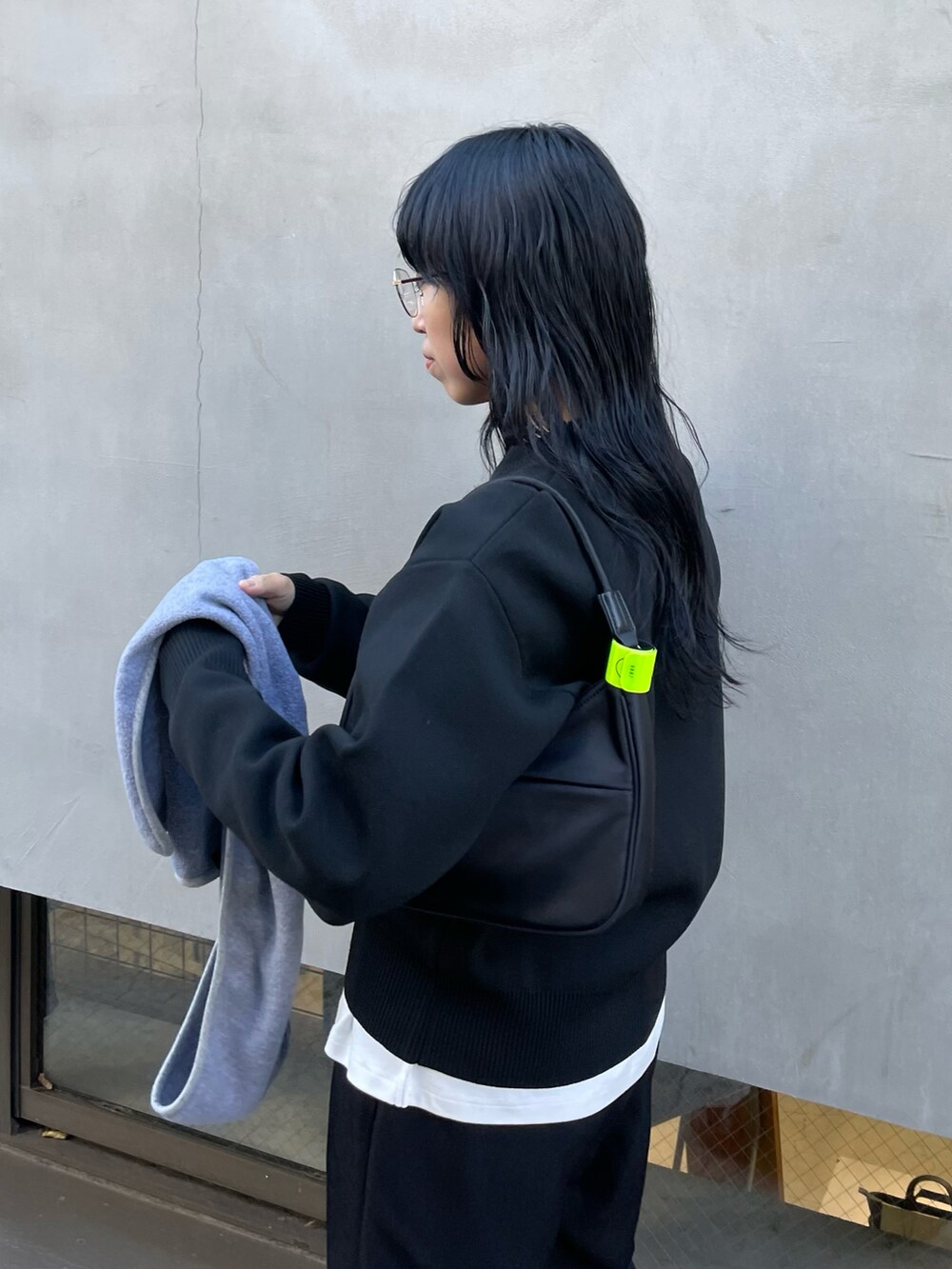 ブラック系のその他パンツ、ブラック系のニット/セーター、ブラック系のハンドバッグを着用したレディースの秋コーディネートの3枚目の写真