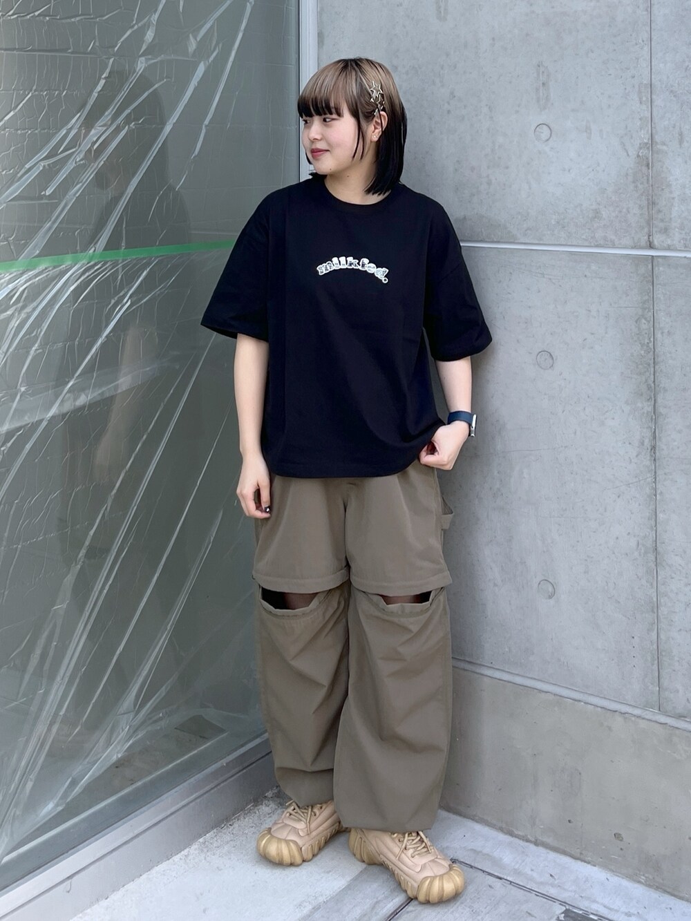 ブラック系のTシャツ/カットソー、ブラック系のハンドバッグ、グリーン系のその他パンツを着用したレディースの春コーディネートの3枚目の写真