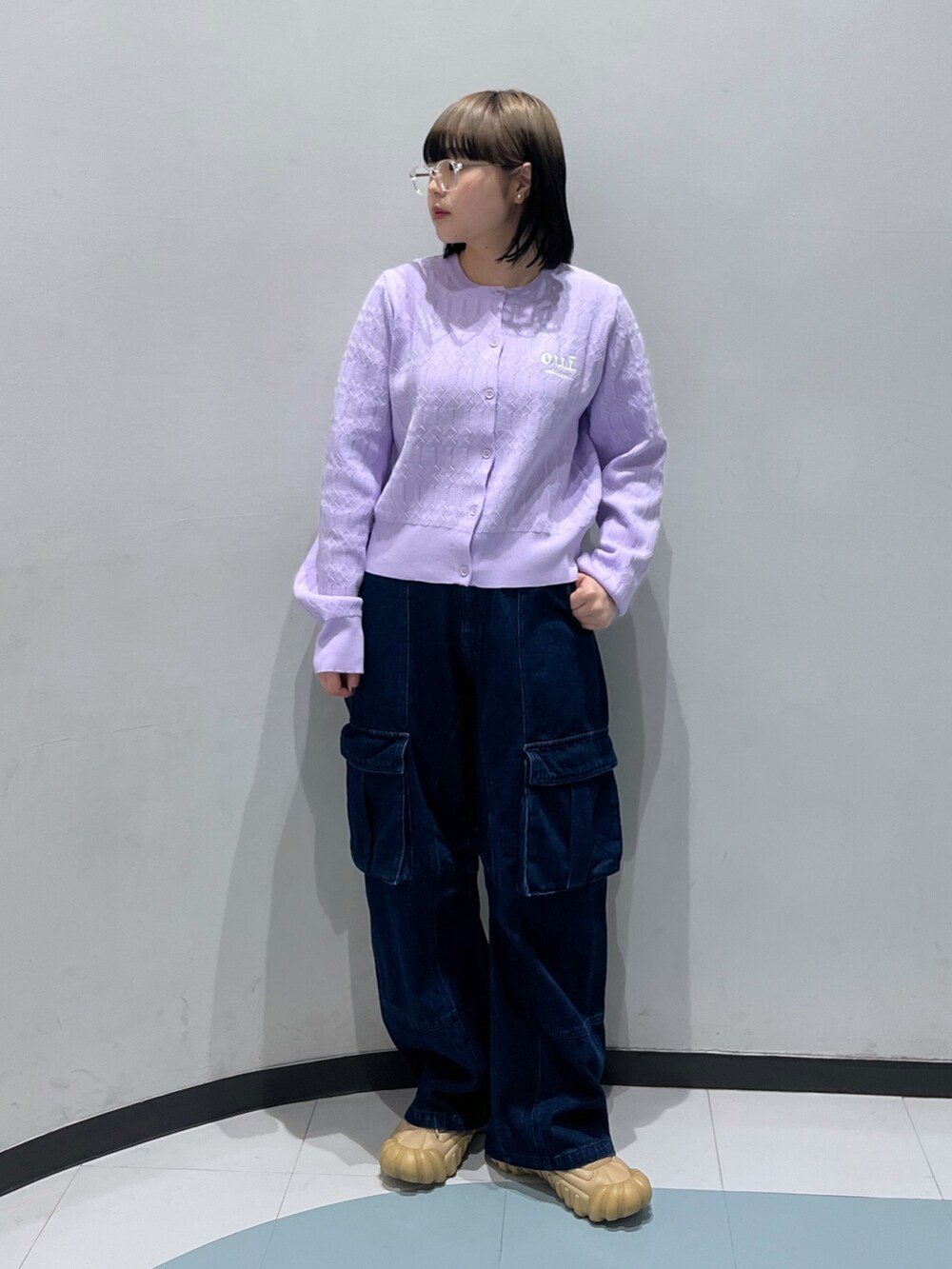 パープル系のカーディガン/ボレロ、ブラック系のショルダーバッグ、ブルー系のカーゴパンツを着用したレディースの春コーディネートの3枚目の写真