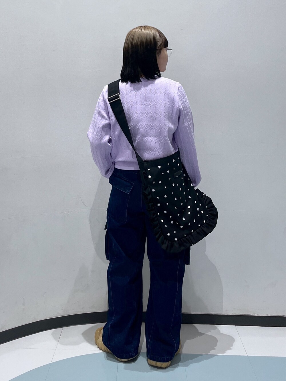 パープル系のカーディガン/ボレロ、ブラック系のショルダーバッグ、ブルー系のカーゴパンツを着用したレディースの春コーディネートの2枚目の写真