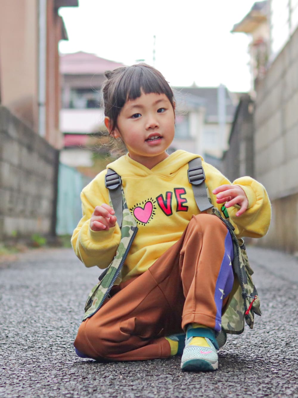 イエロー系のパーカー、その他のベスト、ブラウン系のその他パンツを着用したキッズの冬コーディネートの5枚目の写真