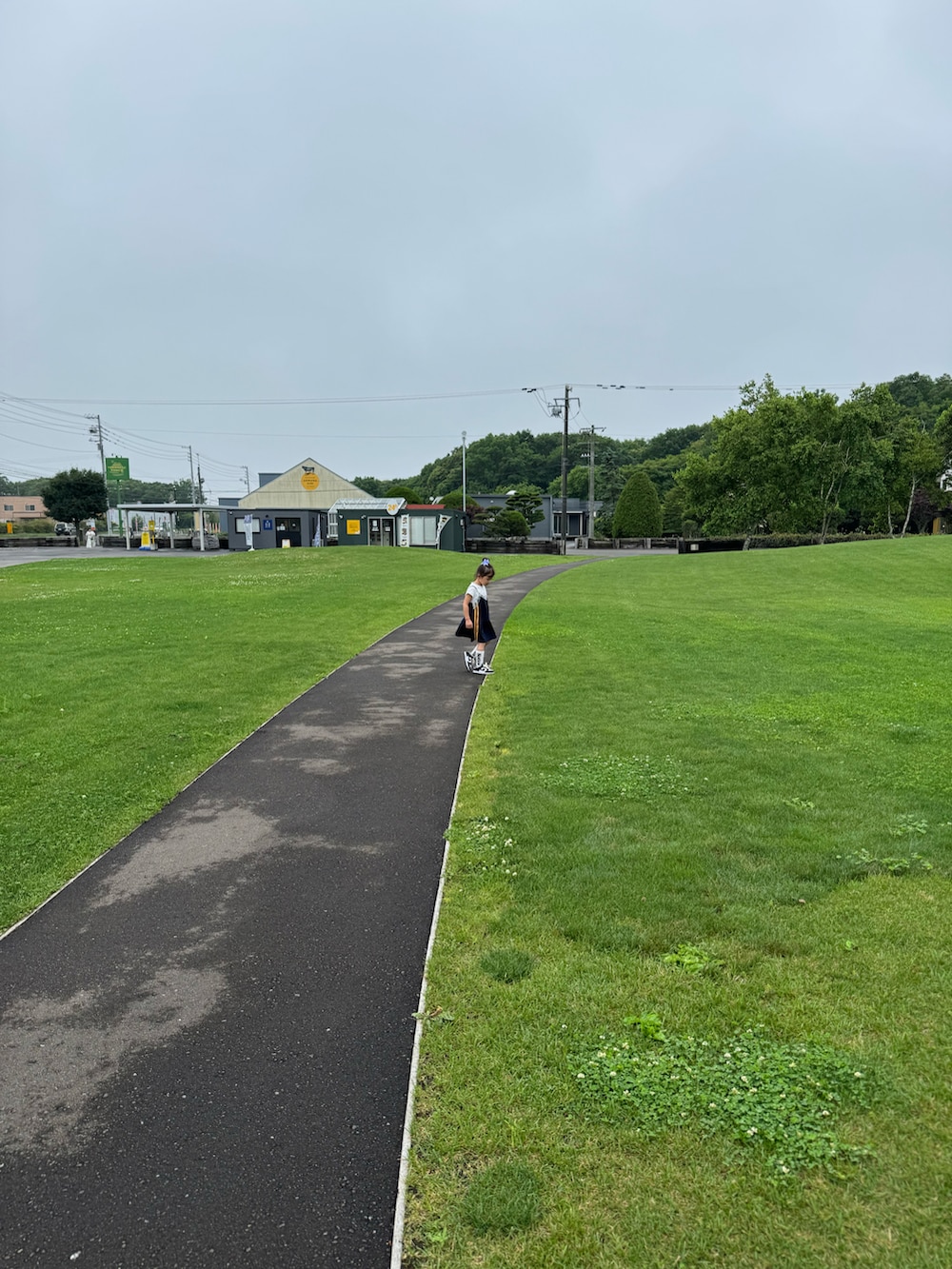 ホワイト系のスニーカー、ブルー系のチュニック、ブラック系のチュニックを着用したキッズの夏コーディネートの2枚目の写真