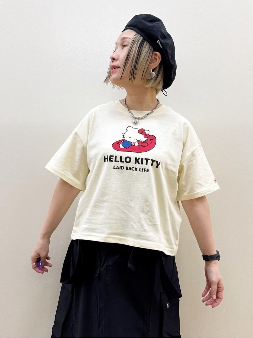 ホワイト系のTシャツ/カットソー、ブラック系のスカート、レッド系のエコバッグ/サブバッグを着用したレディースの春コーディネートの4枚目の写真