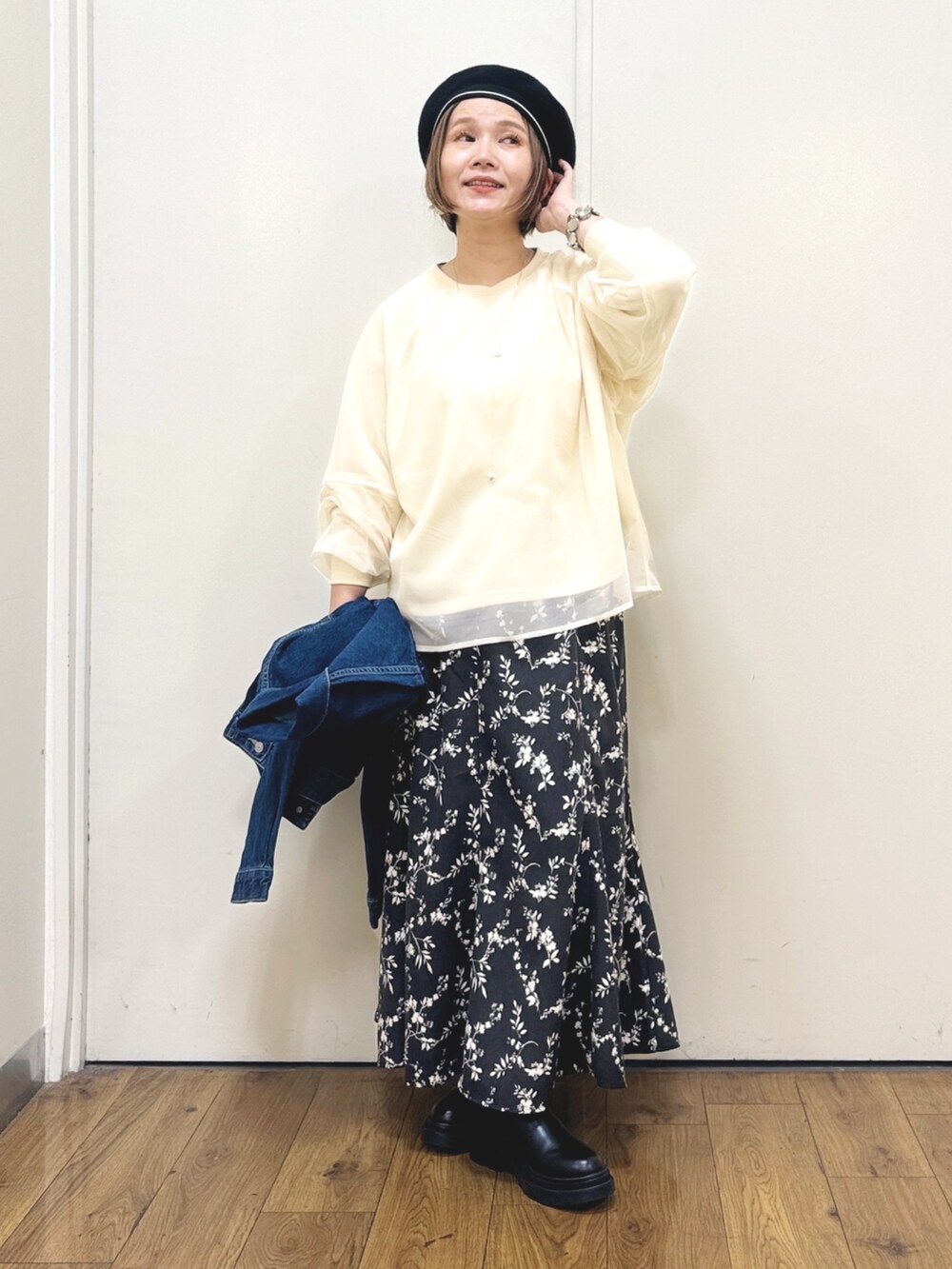 ブルー系のデニムジャケット、ブラック系のスカート、ブラック系のショルダーバッグを着用したレディースの秋コーディネートの2枚目の写真