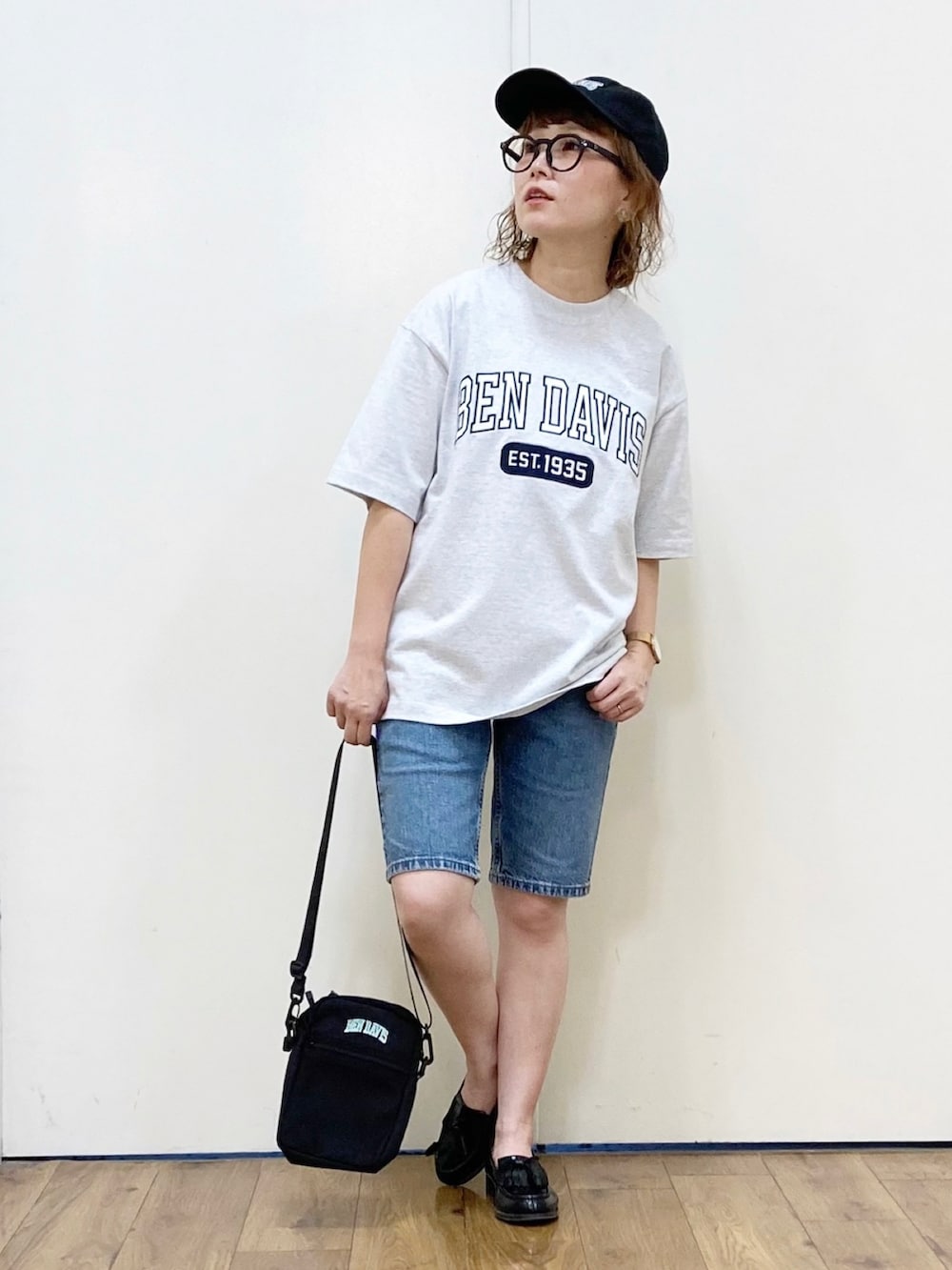 ホワイト系のTシャツ/カットソー、グリーン系のショルダーバッグ、ブルー系のデニムパンツを着用したレディースの夏コーディネートの2枚目の写真