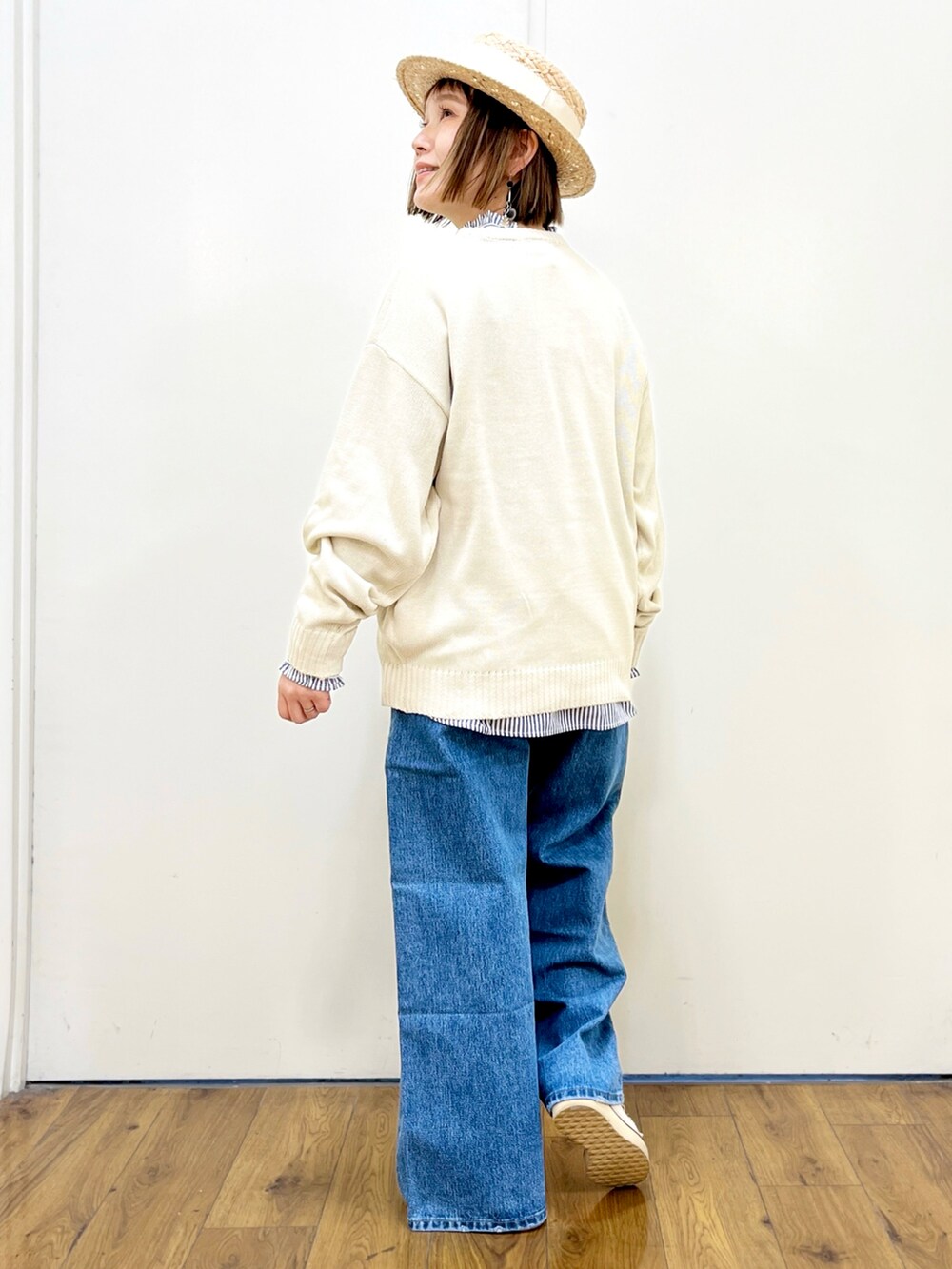 ホワイト系のトートバッグ、ホワイト系のニット/セーター、ブラック系のジャージを着用したレディースの春コーディネートの3枚目の写真