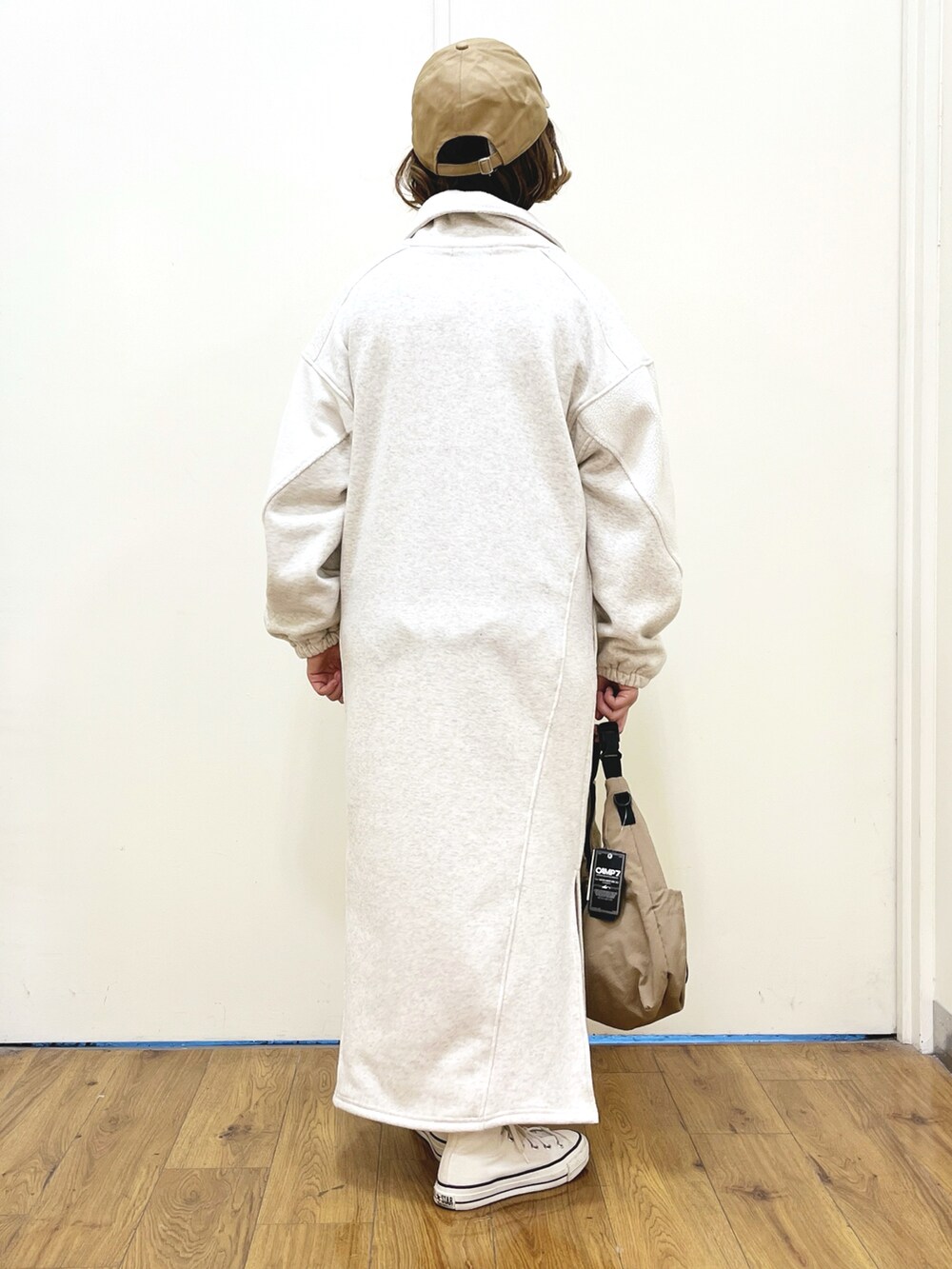 ホワイト系のワンピース、ベージュ系のショルダーバッグ、ホワイト系のニット/セーターを着用したレディースの冬コーディネートの4枚目の写真