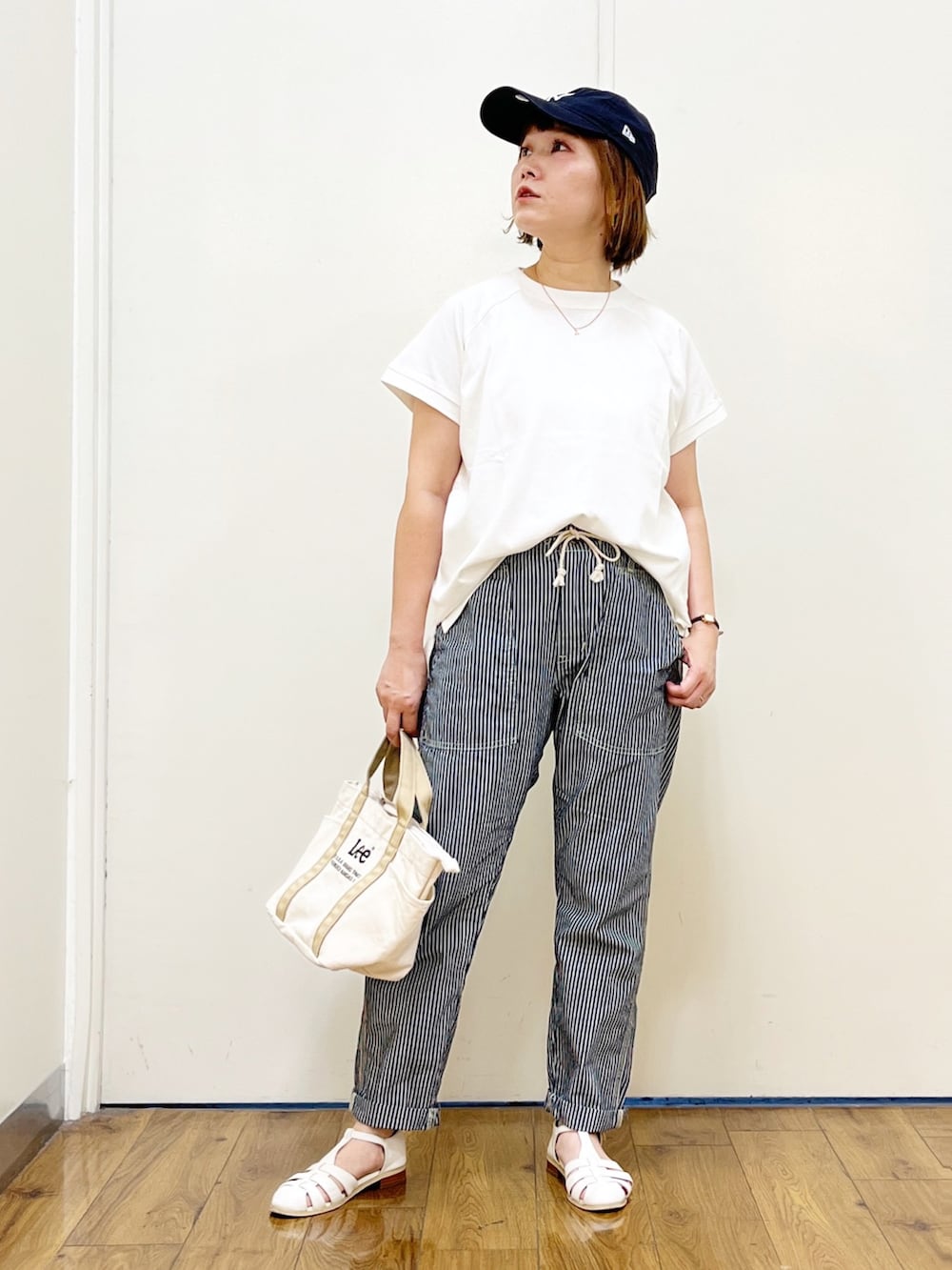 ブルー系のその他パンツ、ベージュ系のトートバッグ、ホワイト系のサンダルを着用したレディースの夏コーディネートの3枚目の写真