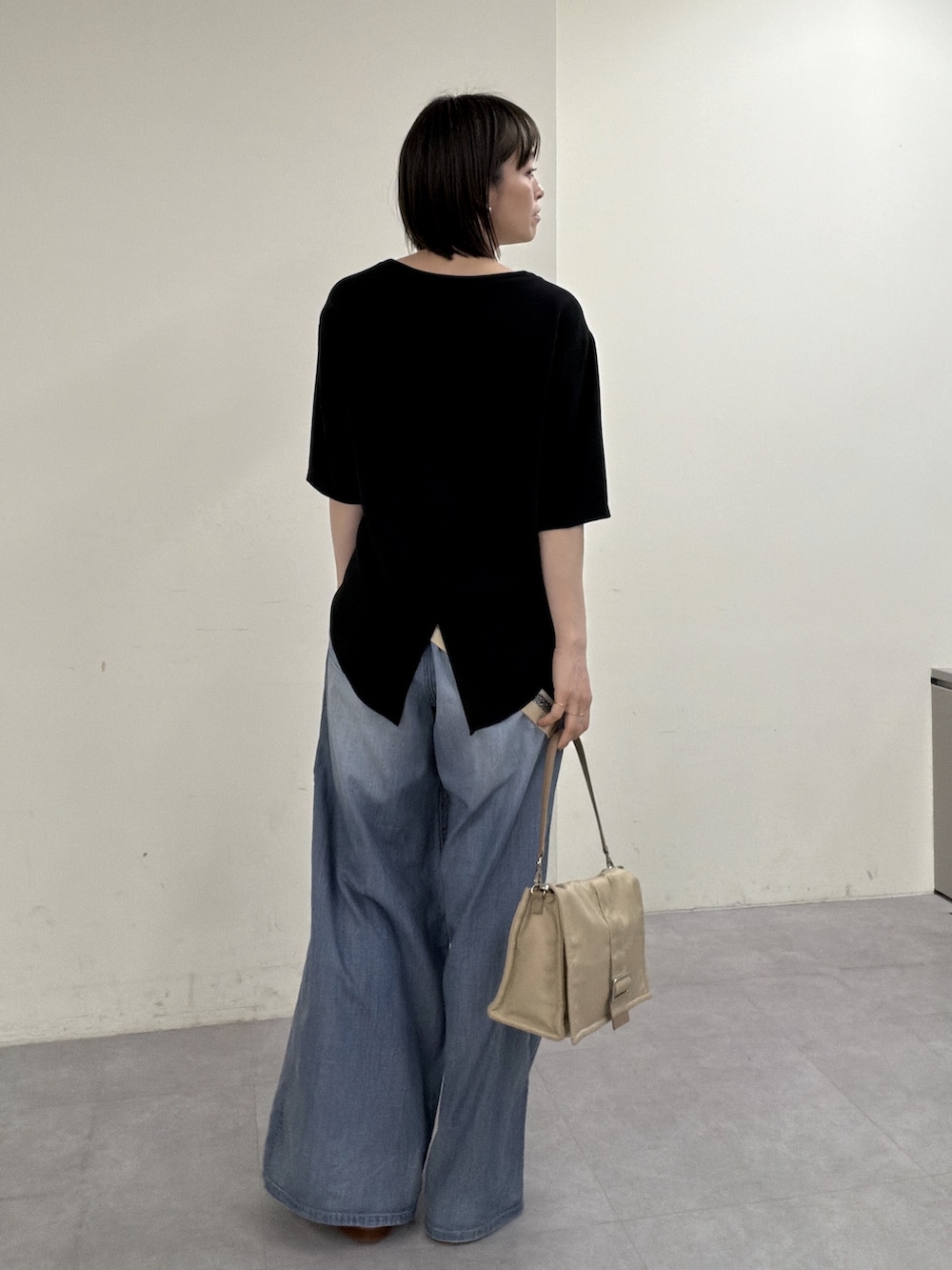 ブラック系のシャツ/ブラウス、ブルー系のその他パンツ、ゴールド系のスリッポンを着用したレディースの春コーディネートの3枚目の写真