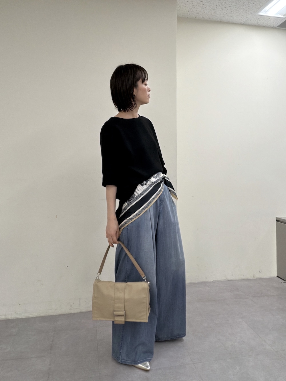 ブラック系のシャツ/ブラウス、ブルー系のその他パンツ、ゴールド系のスリッポンを着用したレディースの春コーディネートの4枚目の写真