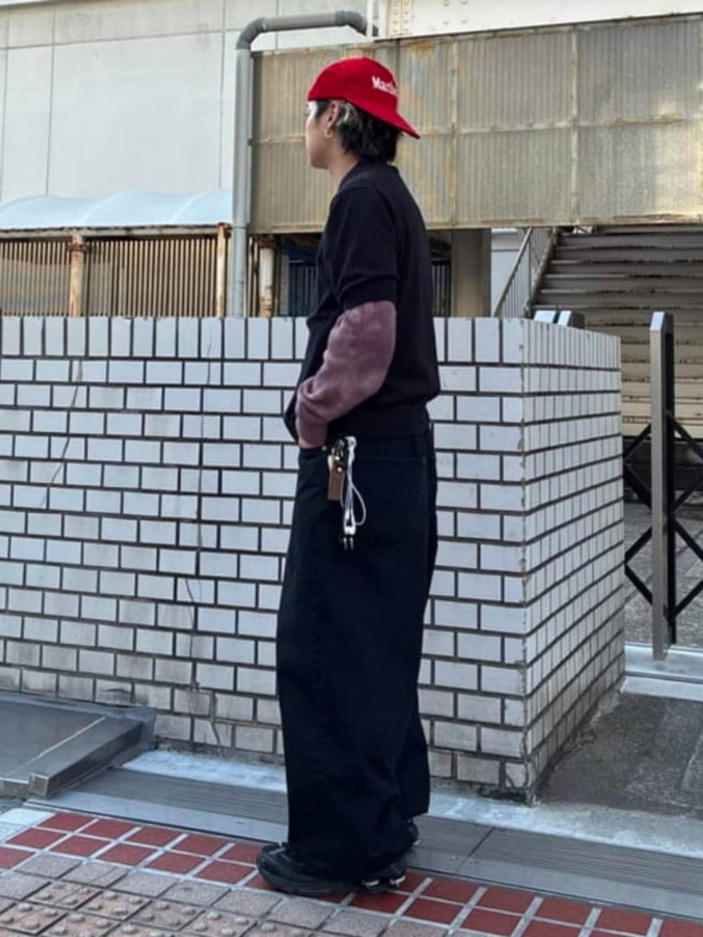 ブラック系のポロシャツ、ピンク系のニット/セーターを着用したメンズの春コーディネートの2枚目の写真
