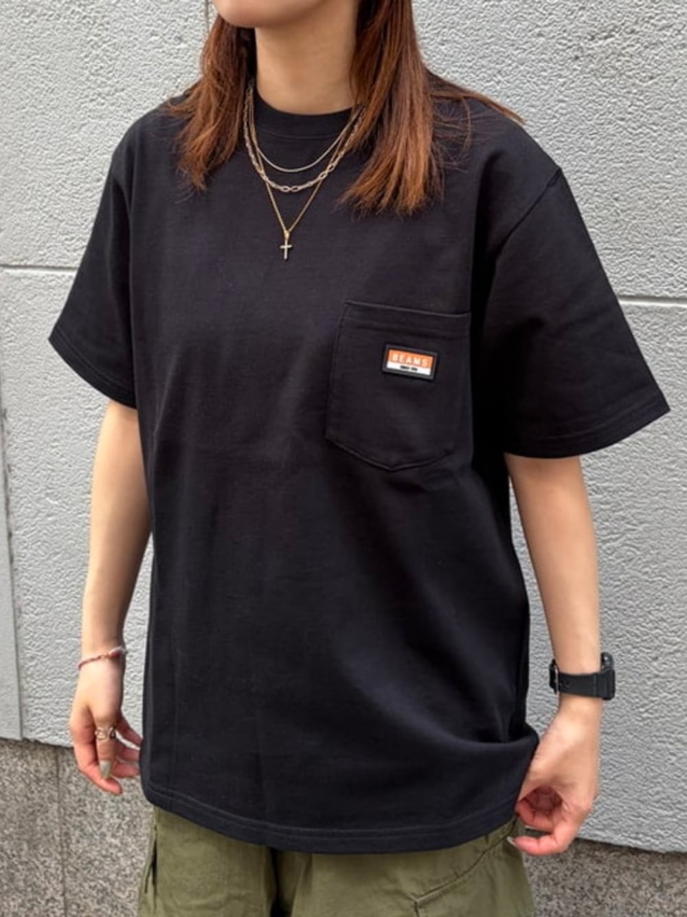 グリーン系のカーゴパンツ、ブラック系のTシャツ/カットソーを着用したメンズの夏コーディネートの3枚目の写真