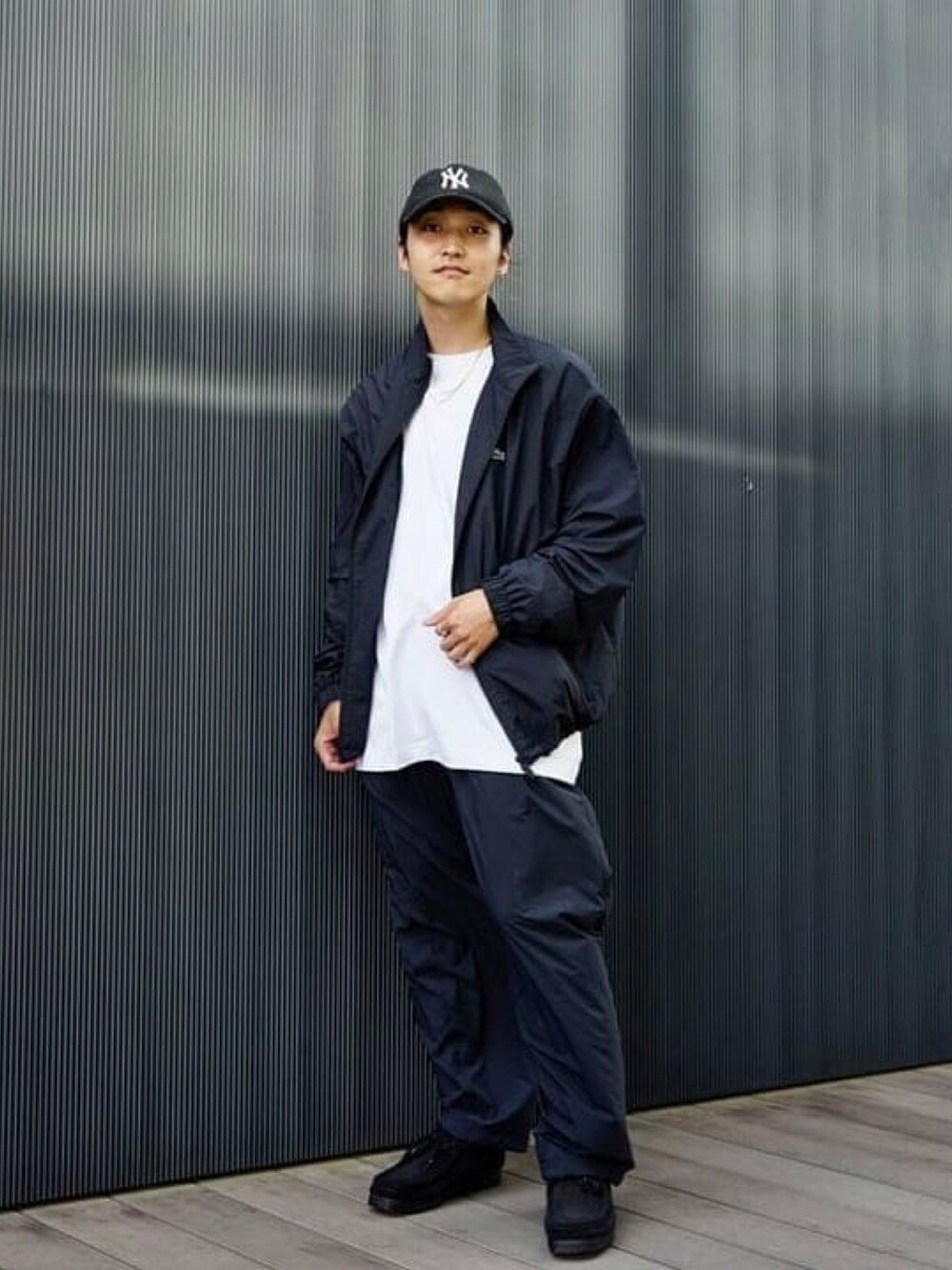 ホワイト系のTシャツ/カットソー、ブラック系のその他パンツ、ブラック系のナイロンジャケットを着用したメンズの秋コーディネートの2枚目の写真