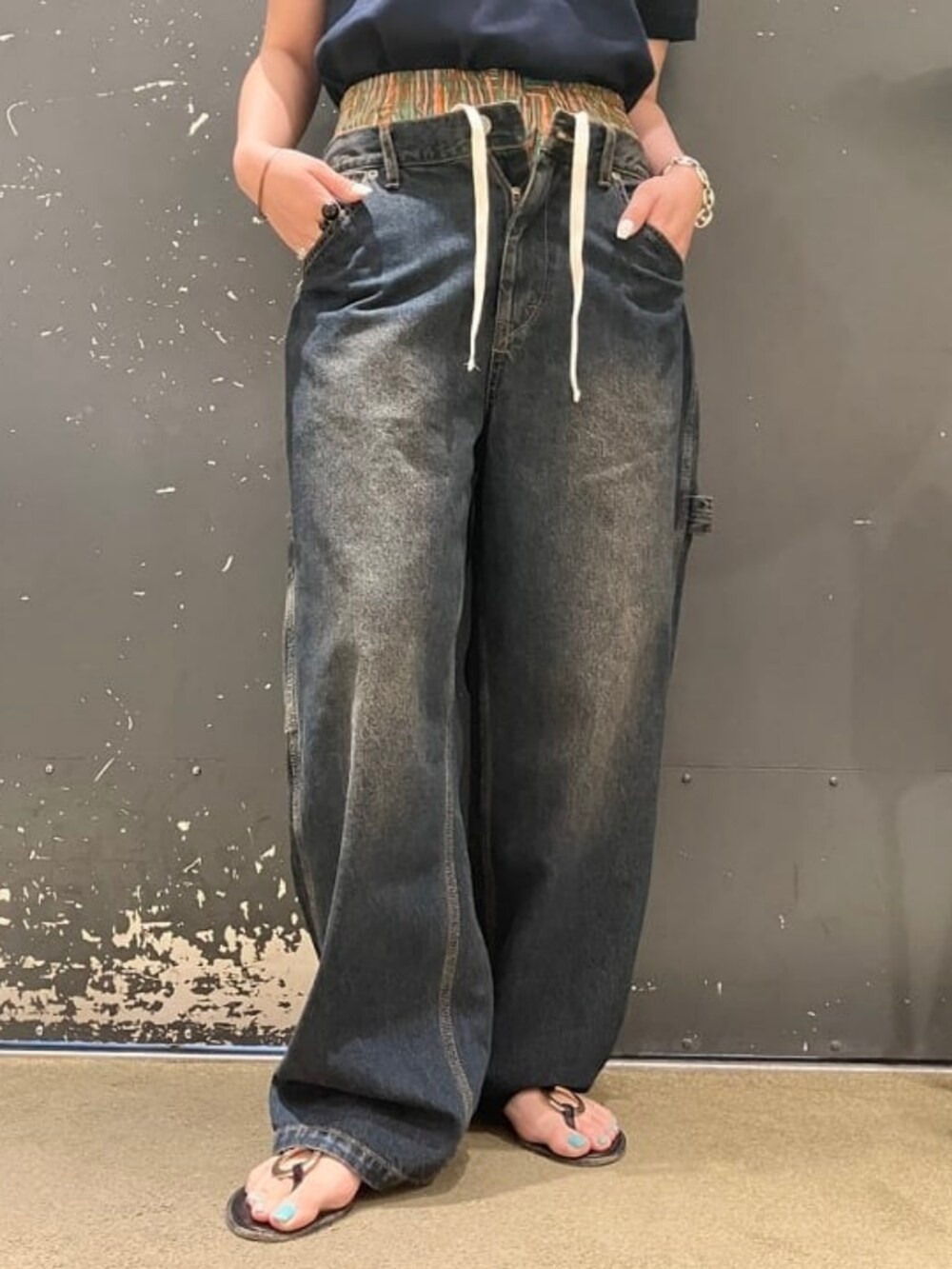 ブルー系のデニムパンツ、ブルー系のポロシャツを着用したレディースの夏コーディネートの3枚目の写真