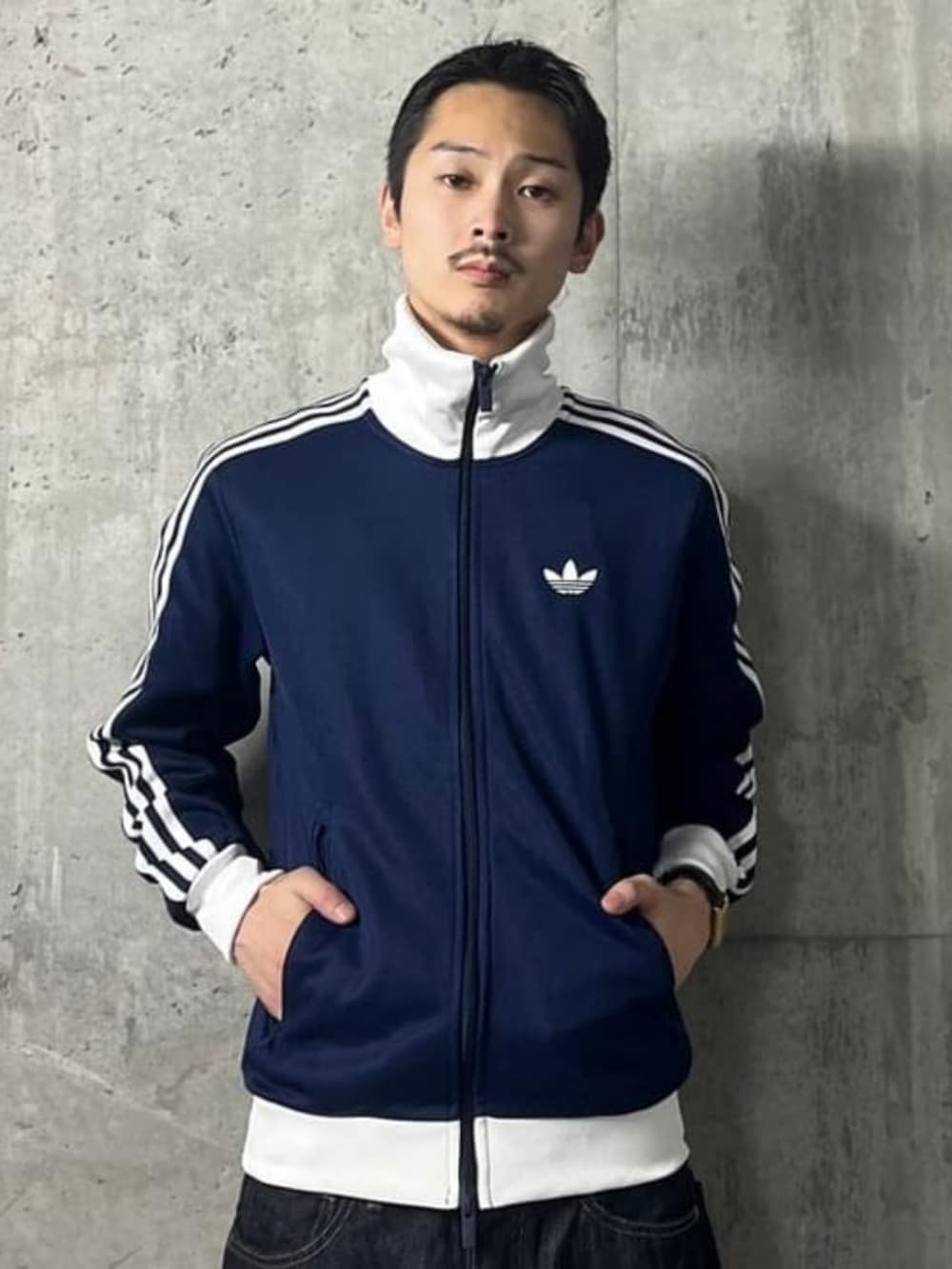ブルー系のデニムパンツ、ブルー系のスウェット、ホワイト系のスニーカーを着用したメンズの秋コーディネートの3枚目の写真