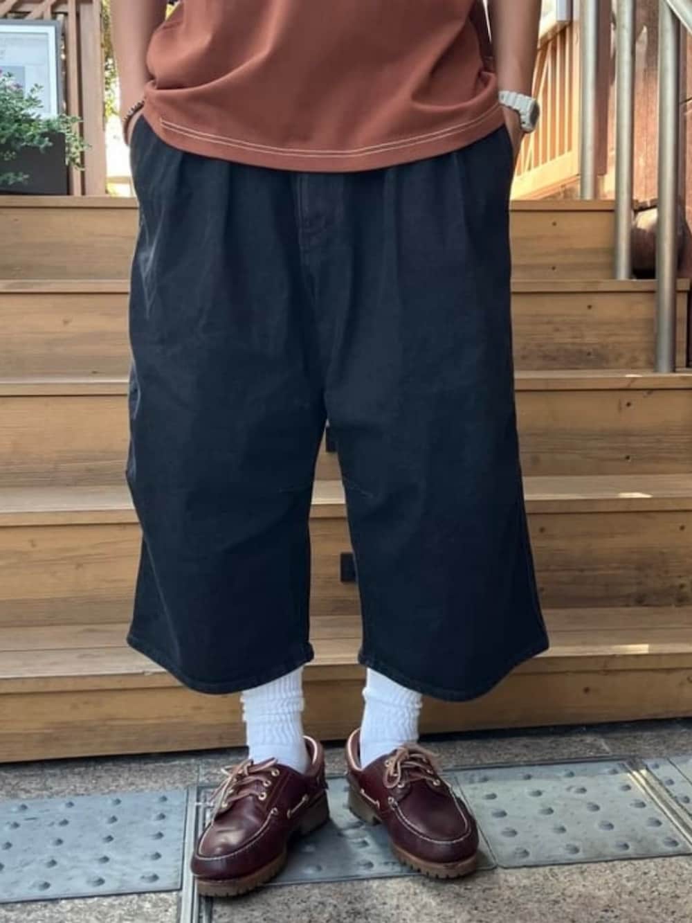 ブラウン系のTシャツ/カットソー、ブラック系のその他パンツ、ブラウン系のハットを着用したメンズの夏コーディネートの2枚目の写真