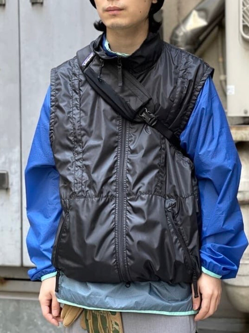 ブラック系のベスト、グレー系のカーゴパンツ、ブラック系のニットキャップ/ビーニーを着用したメンズの春コーディネートの4枚目の写真