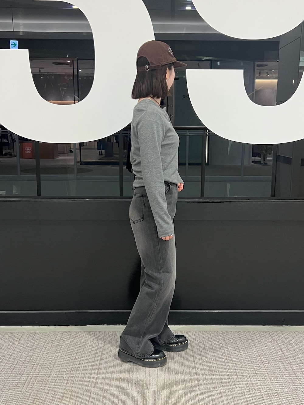 ブラック系のデニムパンツ、グレー系のTシャツ/カットソーを着用したレディースの冬コーディネートの2枚目の写真