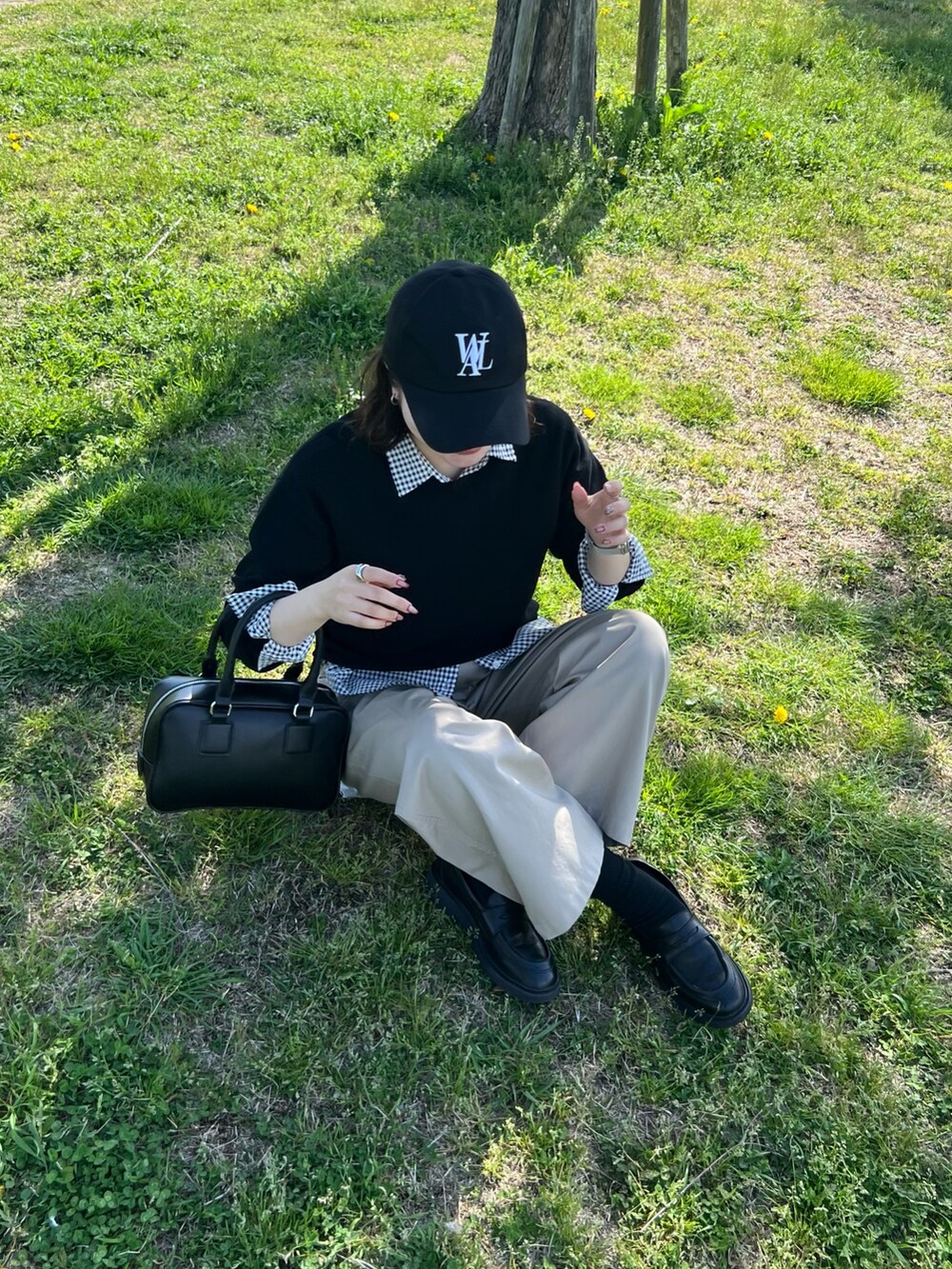 ブラック系のTシャツ/カットソー、ブラック系のシャツ/ブラウス、ベージュ系のチノパンツを着用したレディースの春コーディネートの3枚目の写真