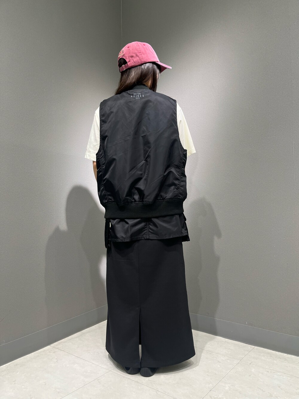 ホワイト系のTシャツ/カットソー、ブラック系のスカート、ブラック系のナイロンジャケットを着用したレディースの夏コーディネートの2枚目の写真