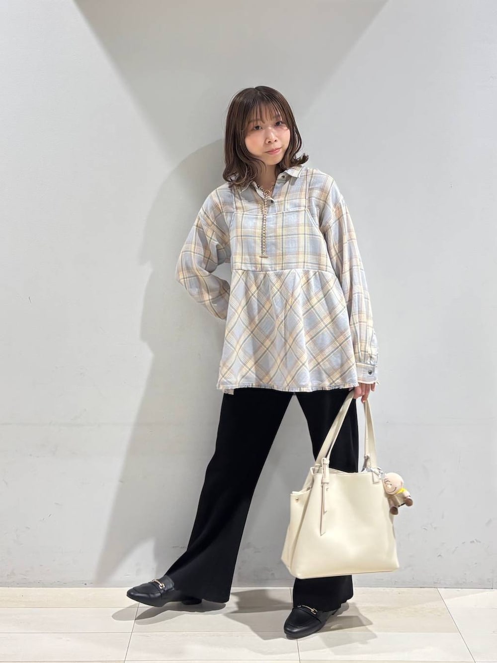 ブラック系のローファー、ホワイト系のハンドバッグ、ブラック系のその他パンツを着用したレディースの冬コーディネートの9枚目の写真