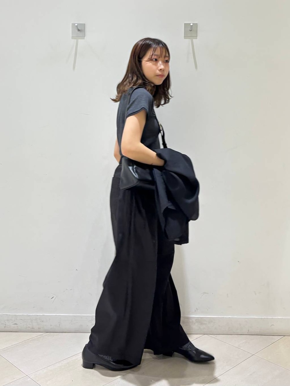 ブラック系のパンプス、ブラック系のショルダーバッグ、ブラック系のその他パンツを着用したレディースの夏コーディネートの3枚目の写真