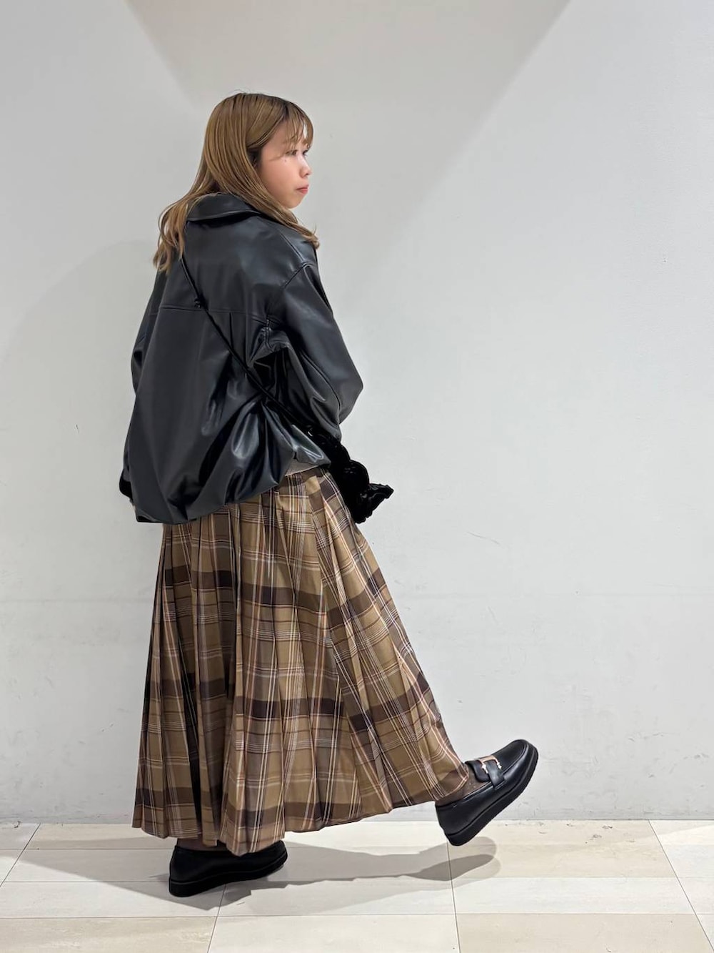 ベージュ系のTシャツ/カットソー、ブラック系のローファー、ブラック系のブルゾンを着用したレディースの秋コーディネートの6枚目の写真