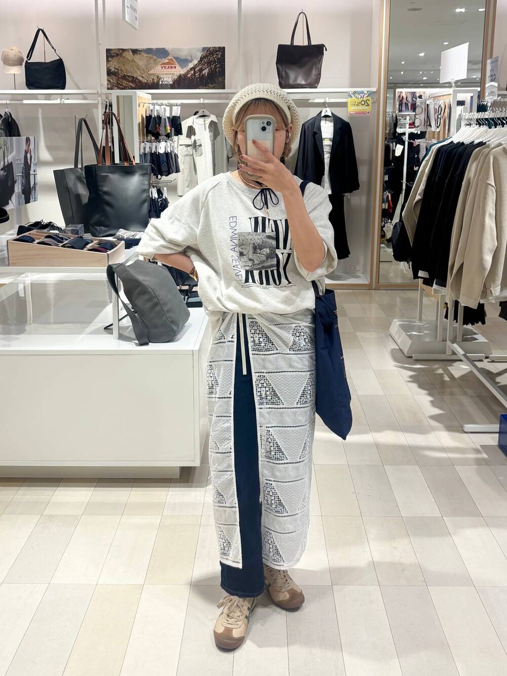 ブルー系のデニムパンツ、グレー系のTシャツ/カットソー、ゴールド系のネックレスを着用したレディースの秋コーディネートの5枚目の写真