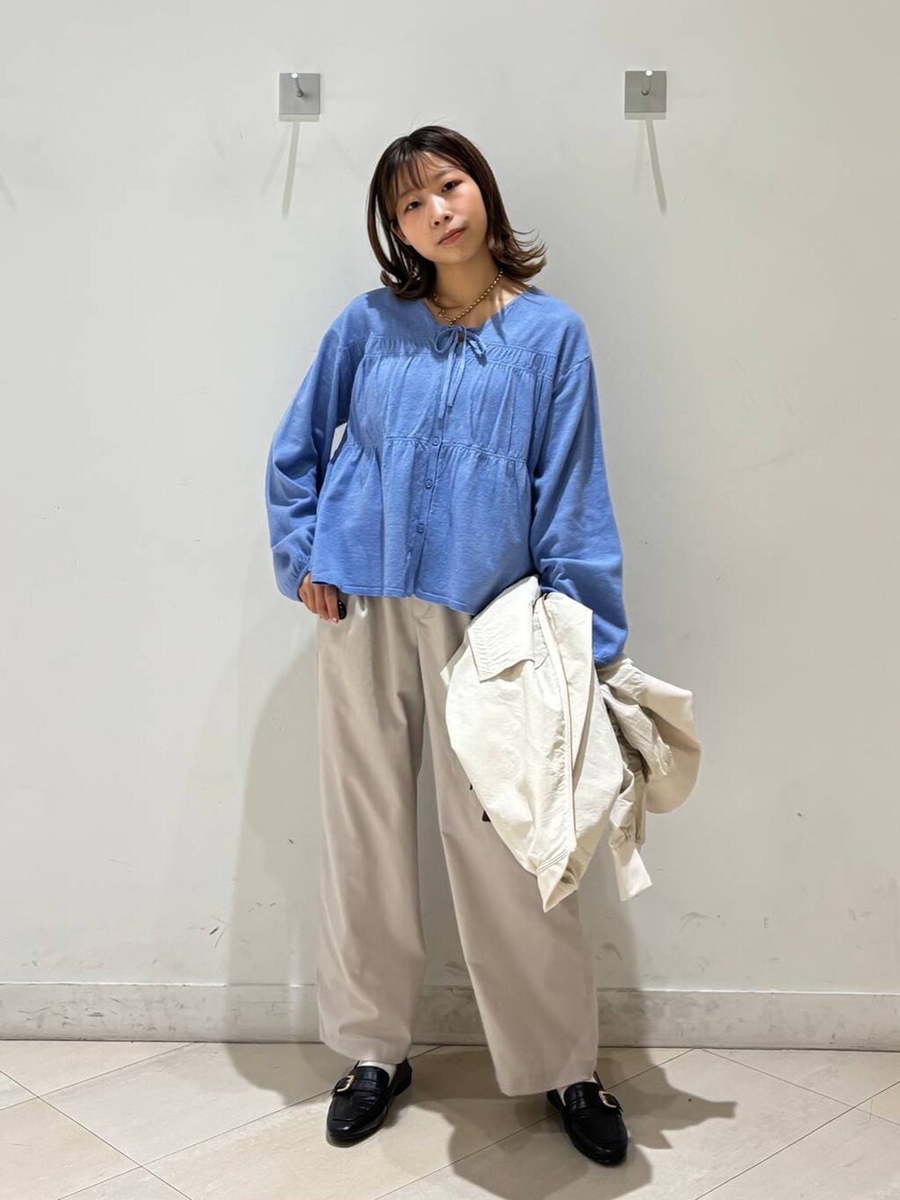 ブラック系のローファー、ホワイト系のその他パンツ、ブラウン系のボストンバッグを着用したレディースの春コーディネートの8枚目の写真