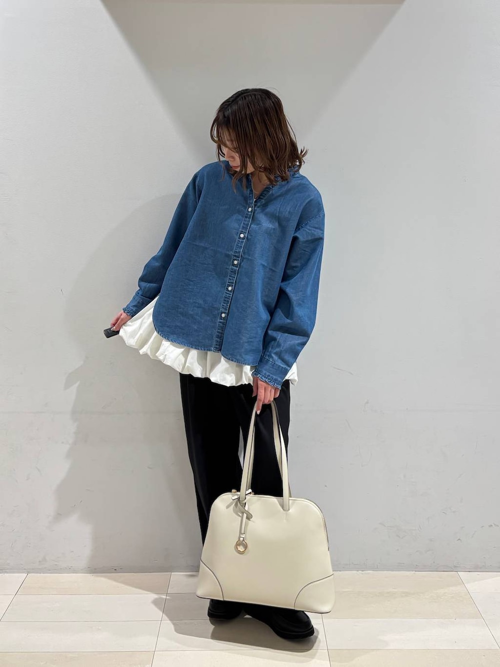 ブラック系のローファー、ベージュ系のボストンバッグ、ブルー系のシャツ/ブラウスを着用したレディースの春コーディネートの9枚目の写真