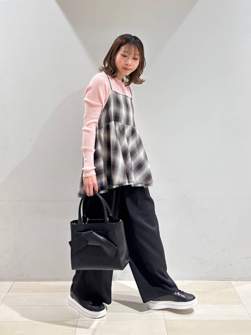 ブラック系のハンドバッグ、ブラック系のその他パンツ、ブラウン系のその他トップスを着用したレディースの春コーディネートの2枚目の写真