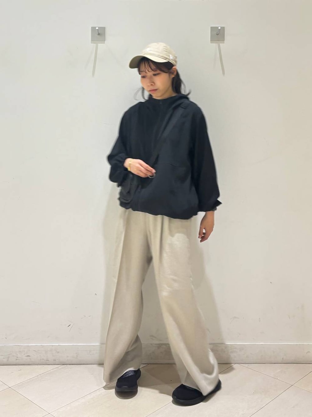 ベージュ系のその他パンツ、ブラック系のマウンテンパーカー、ブラック系のスニーカーを着用したレディースの春コーディネートの3枚目の写真
