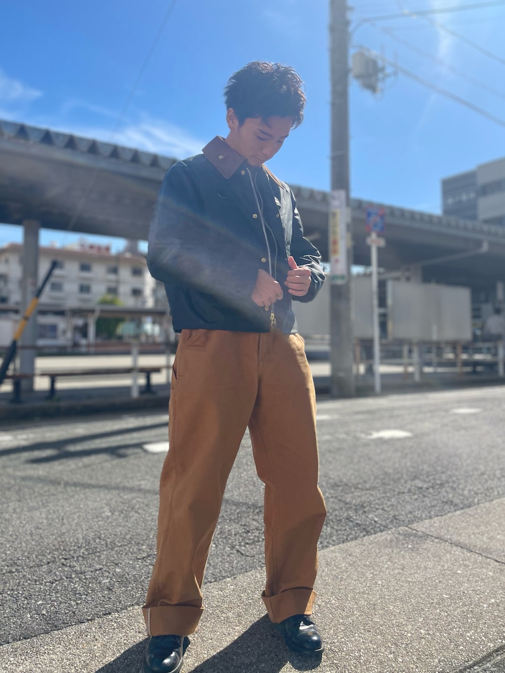 グリーン系のジャケット/アウター、ブラウン系のチノパンツを着用したメンズの秋コーディネートの3枚目の写真