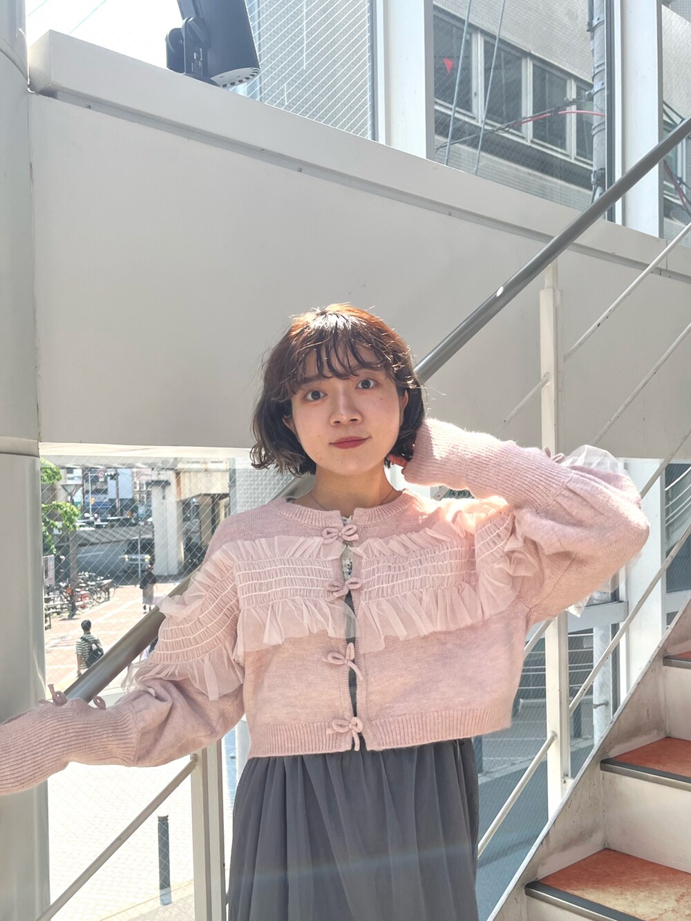 グレー系のワンピース、ピンク系のカーディガン/ボレロ、ホワイト系のTシャツ/カットソーを着用したレディースの秋コーディネートの5枚目の写真